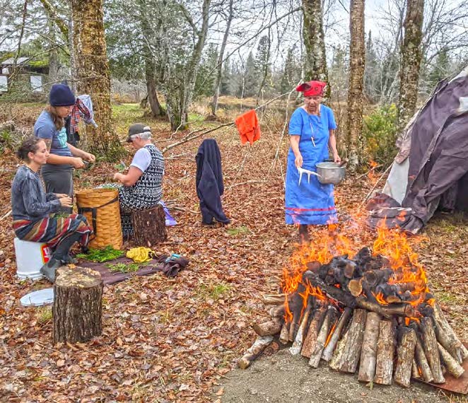 A group of people around a camp fire
