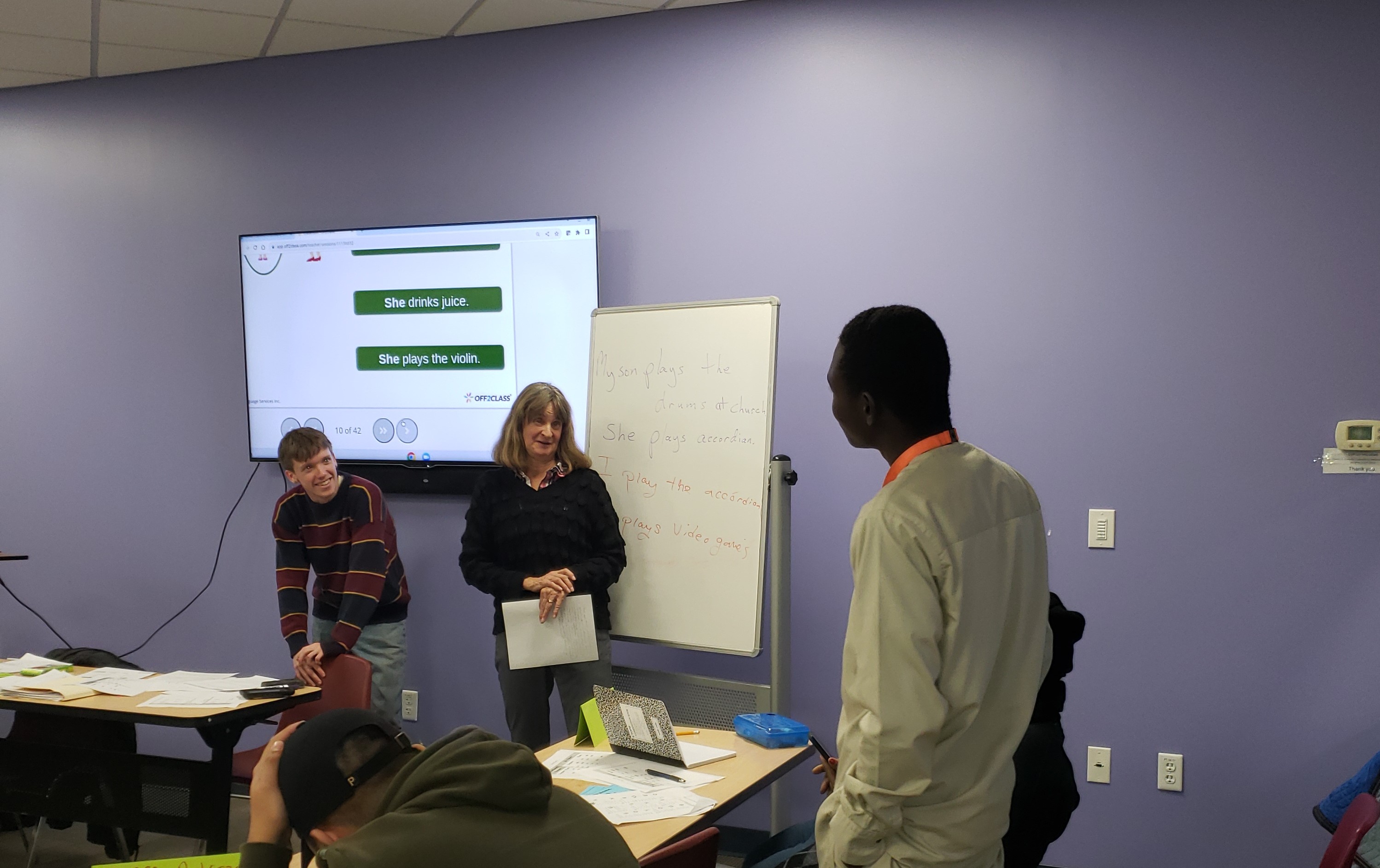 Adonis in the classroom helping a French-speaking student