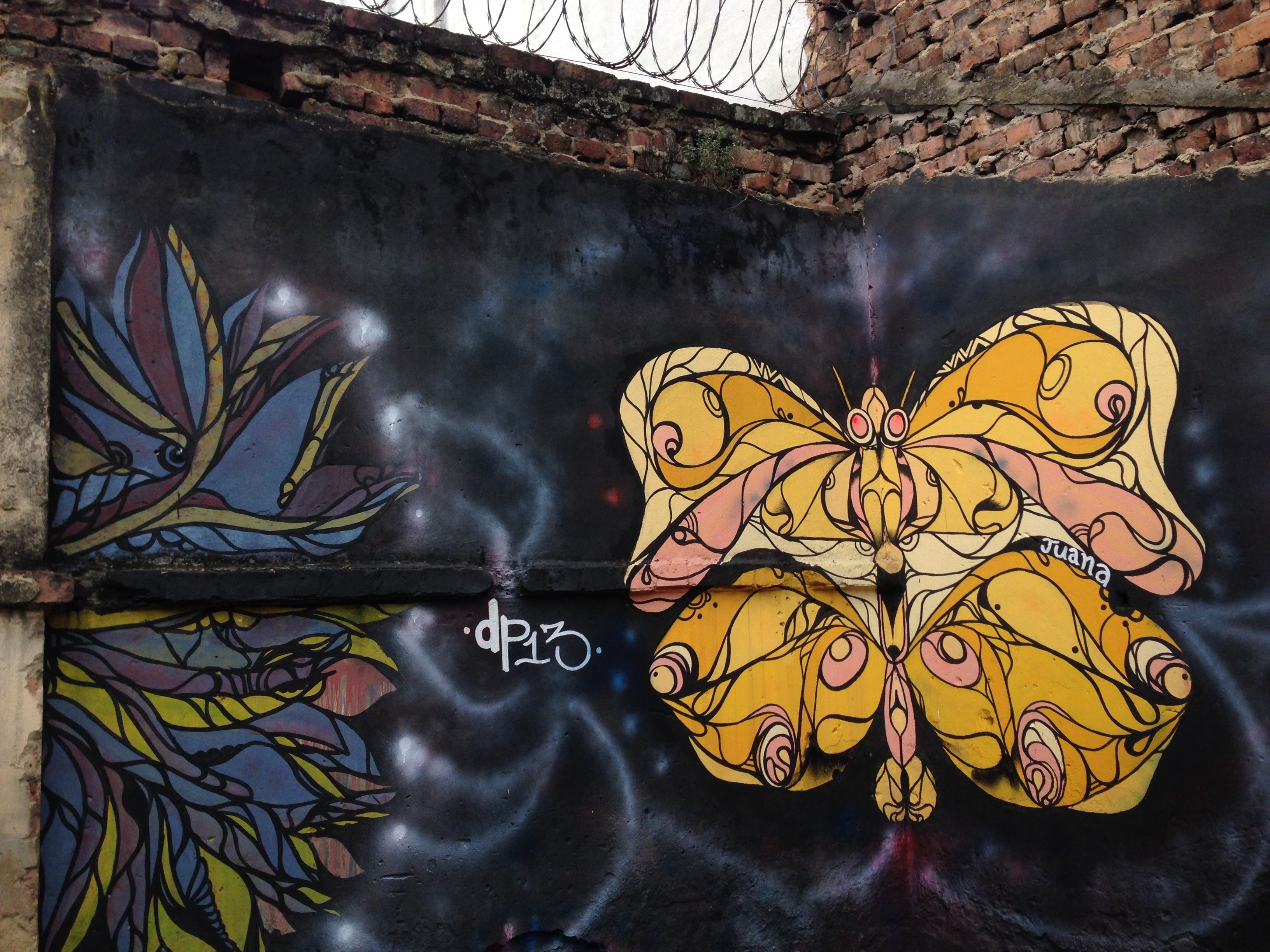 A mural image of a yellow butterfly painted on a wall.