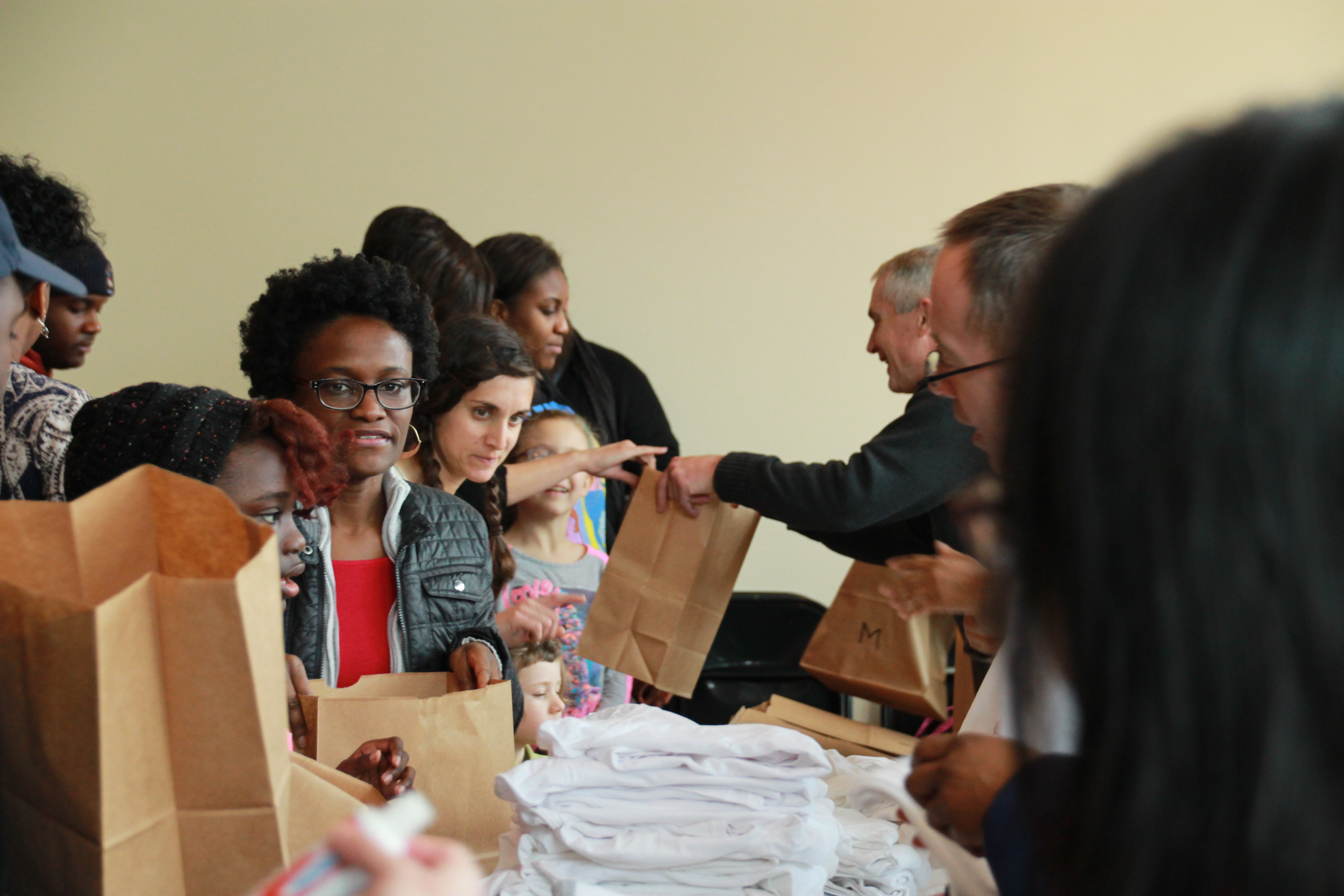 People assembling prison care kits. 