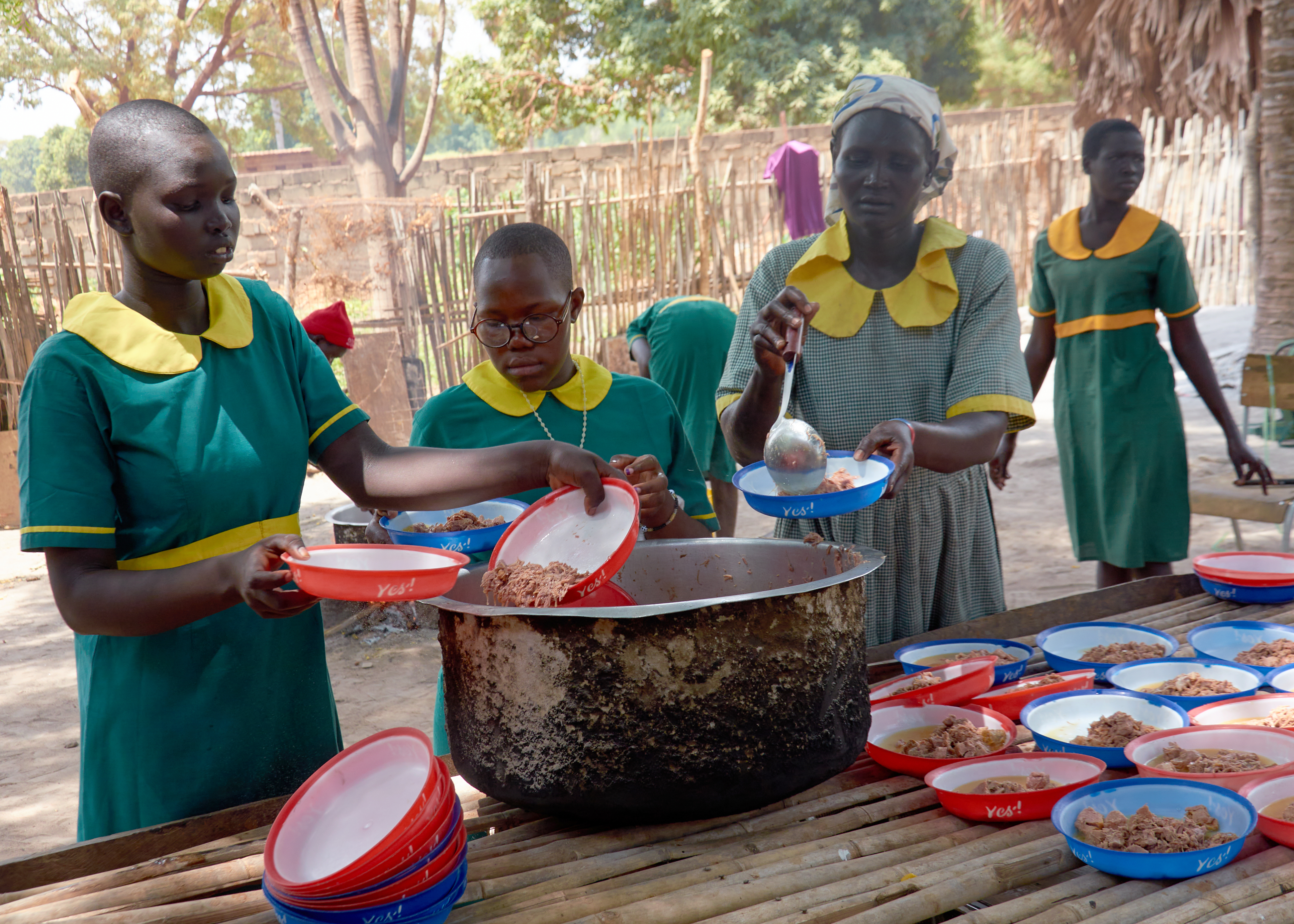 Group of students in South Sudan eating a meal.