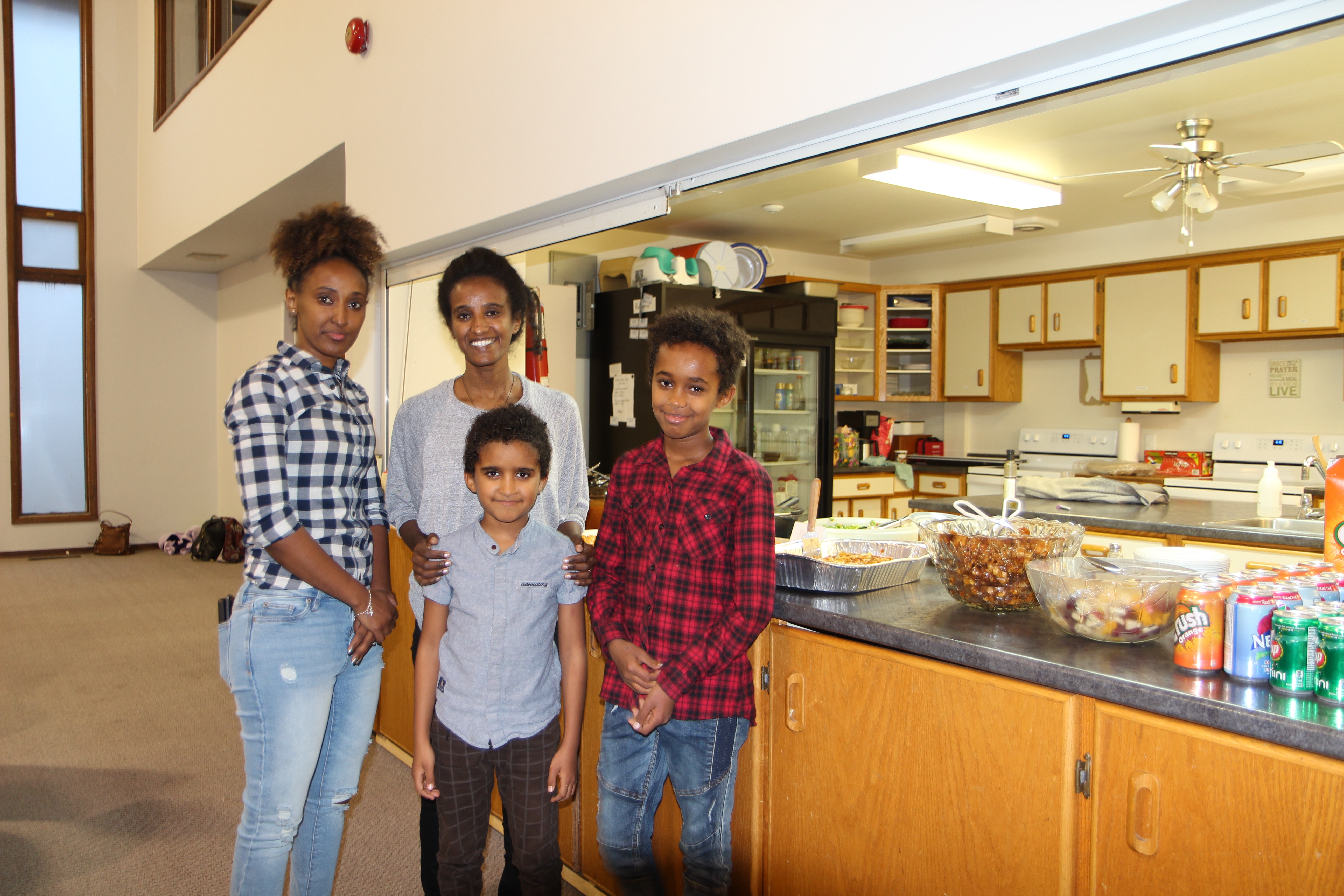 people standing in front of counter with food