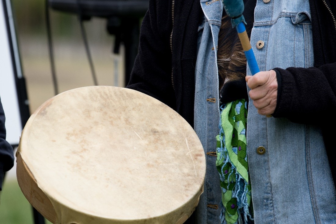 a man playing a hand drum