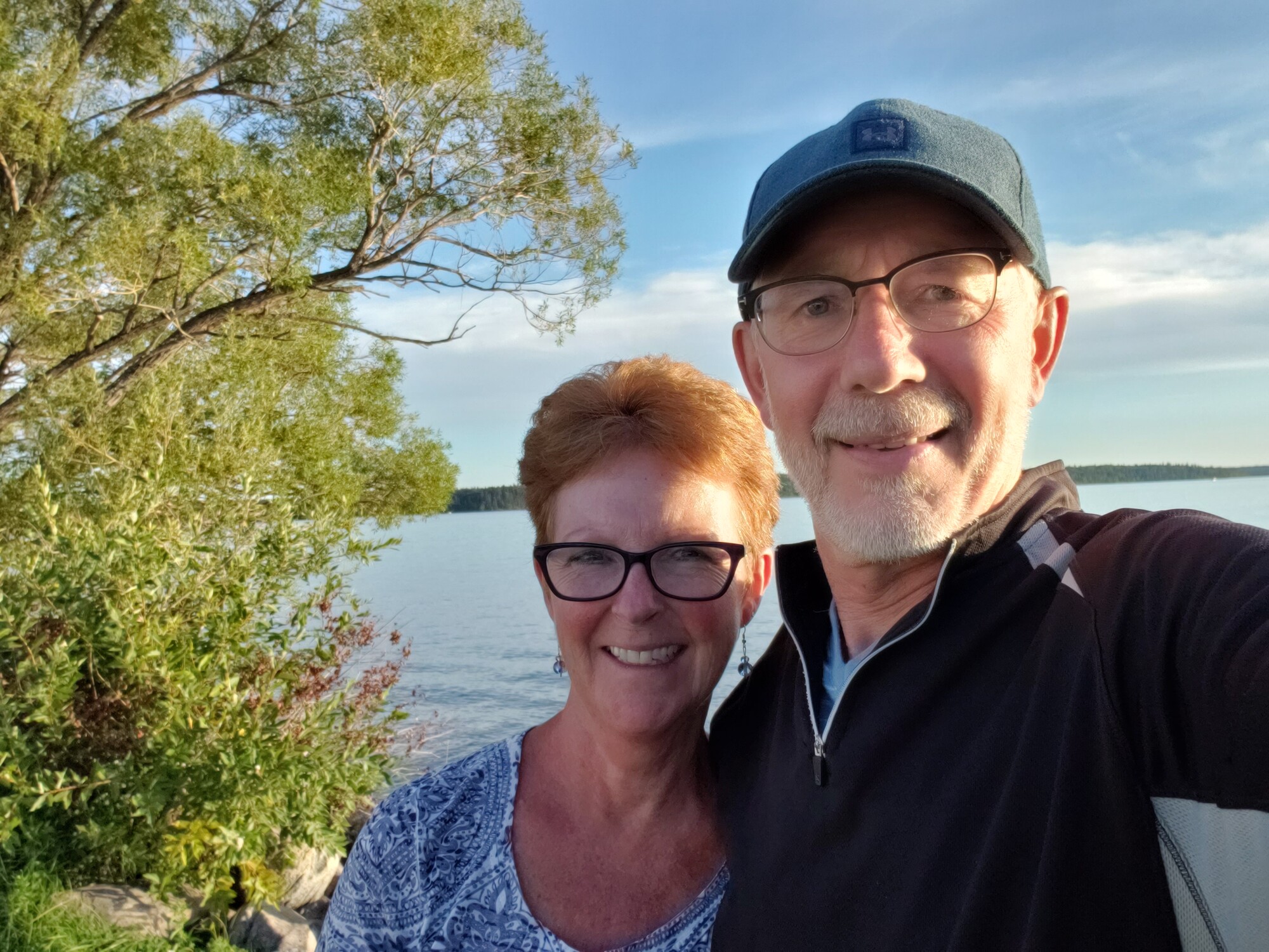 A man and woman smiling taking a selfie style photo