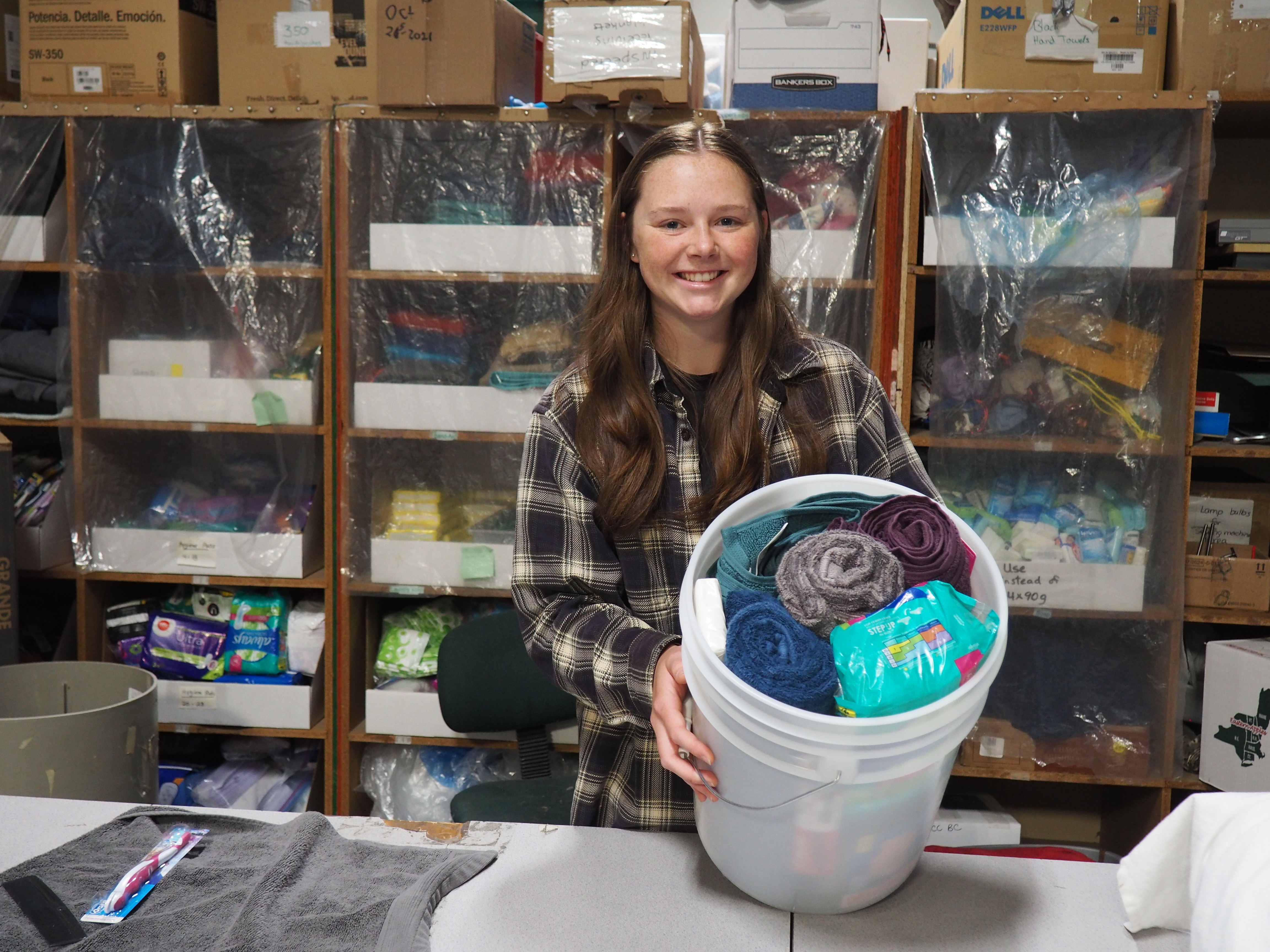 A picture of Tori Klapstein, MCC material resources volunteer, packing relief kits. 