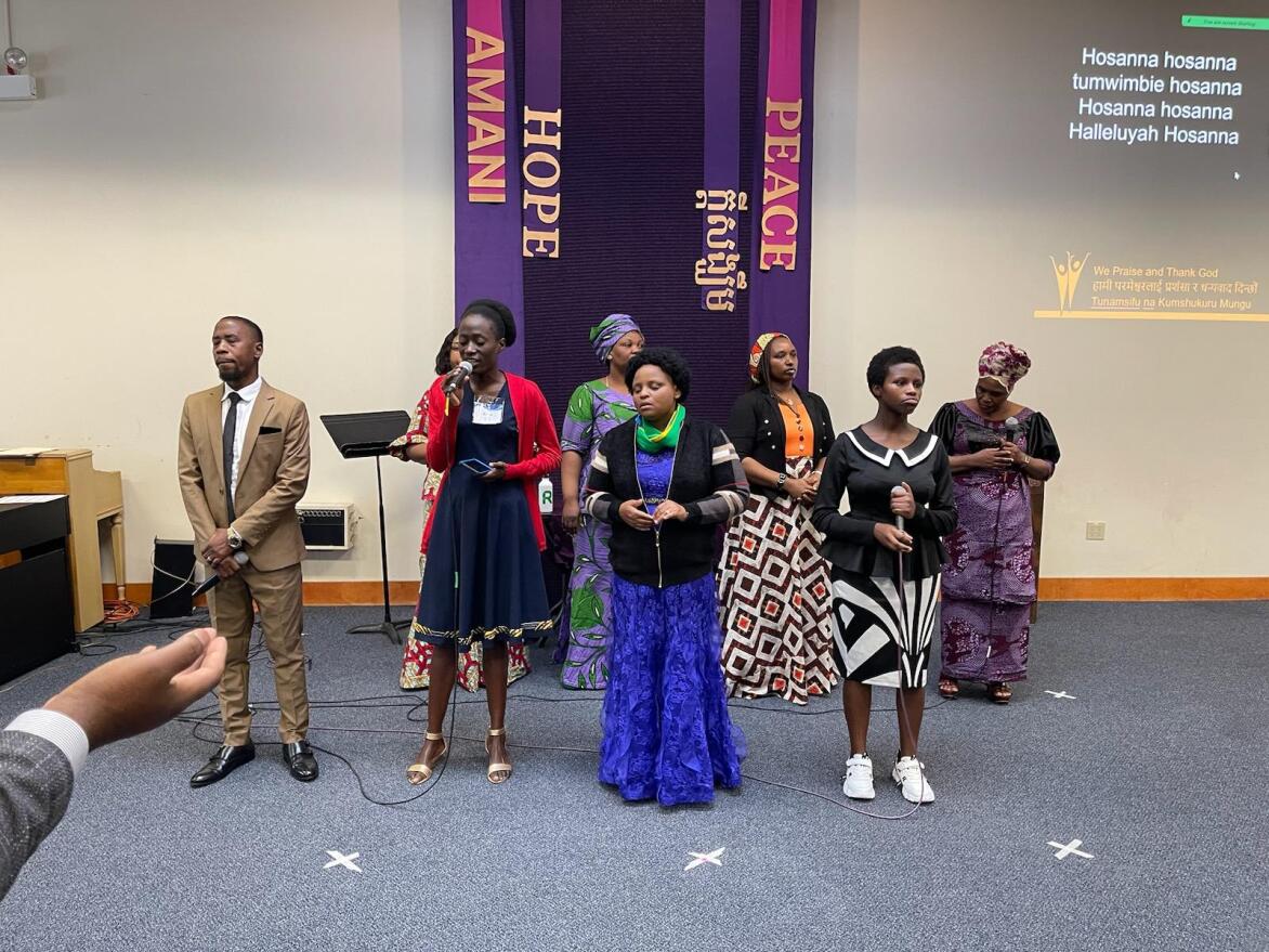 Zilpa Charles, wearing the red cardigan (second from left, front row), leads Unity Choir during a worship service at Living Water Community Church.