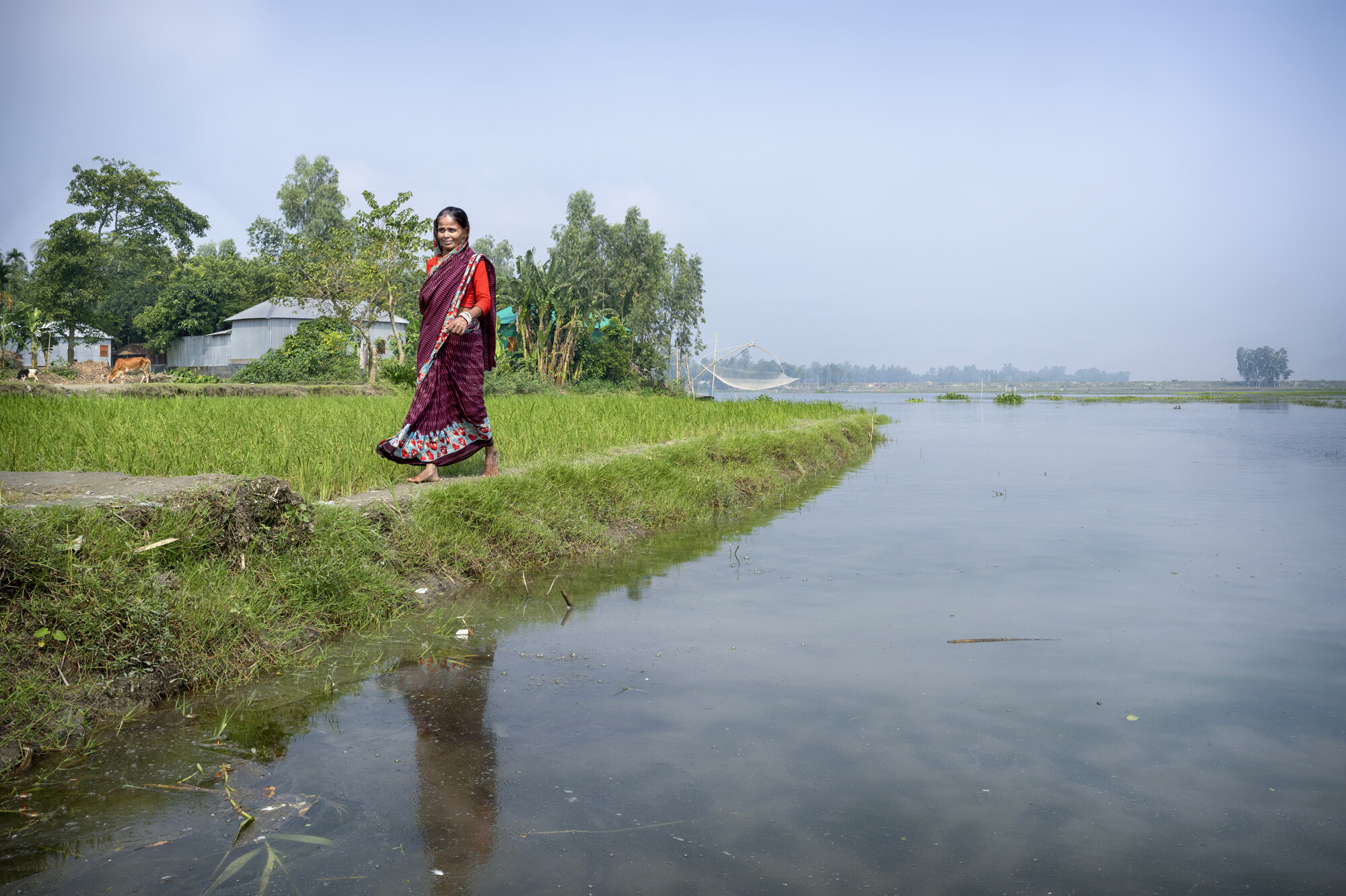 A woman walking by a river