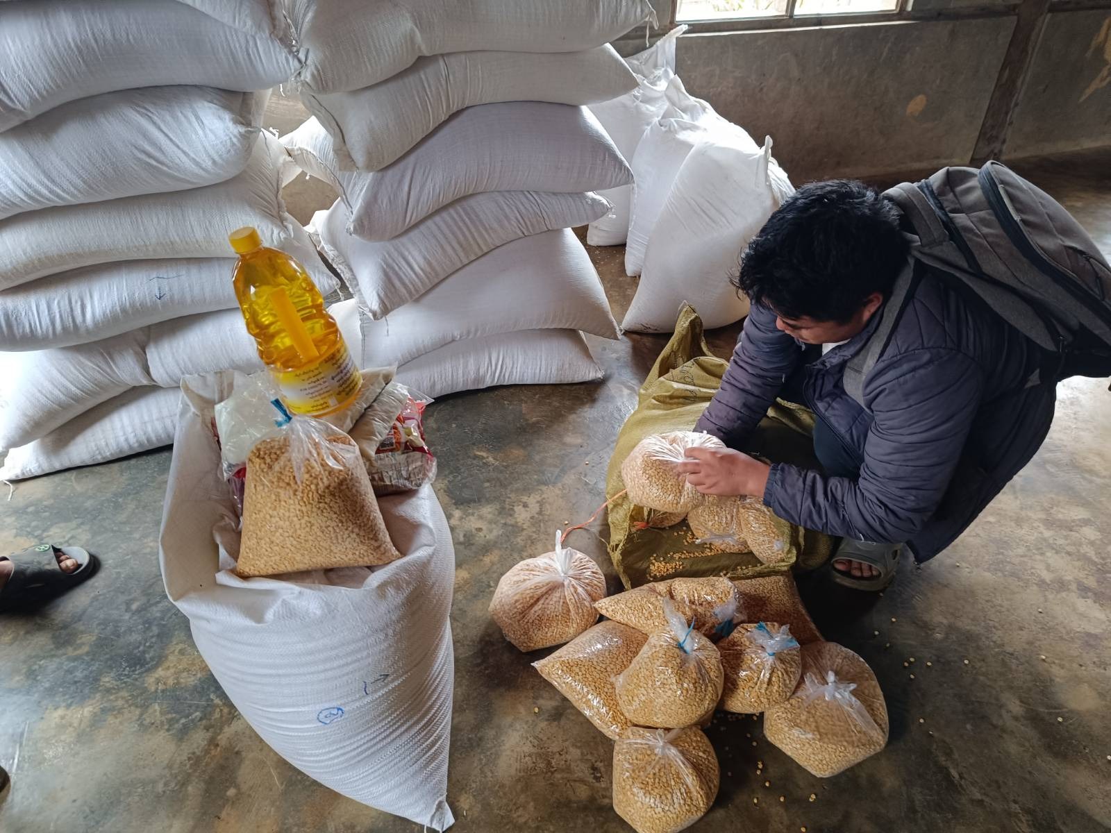 person packaging food for distribution in Myanmar
