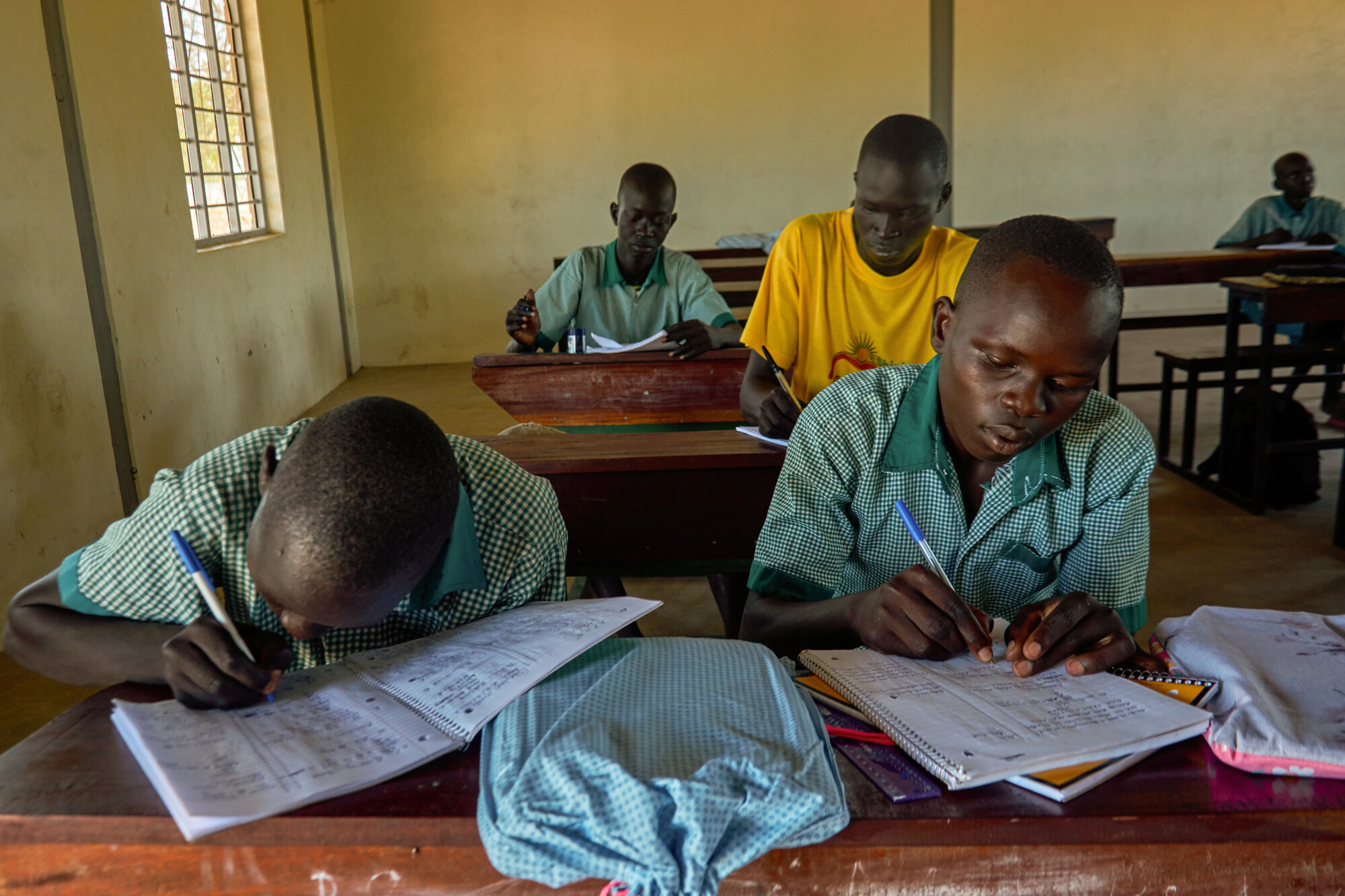 A group of children writing at desks
