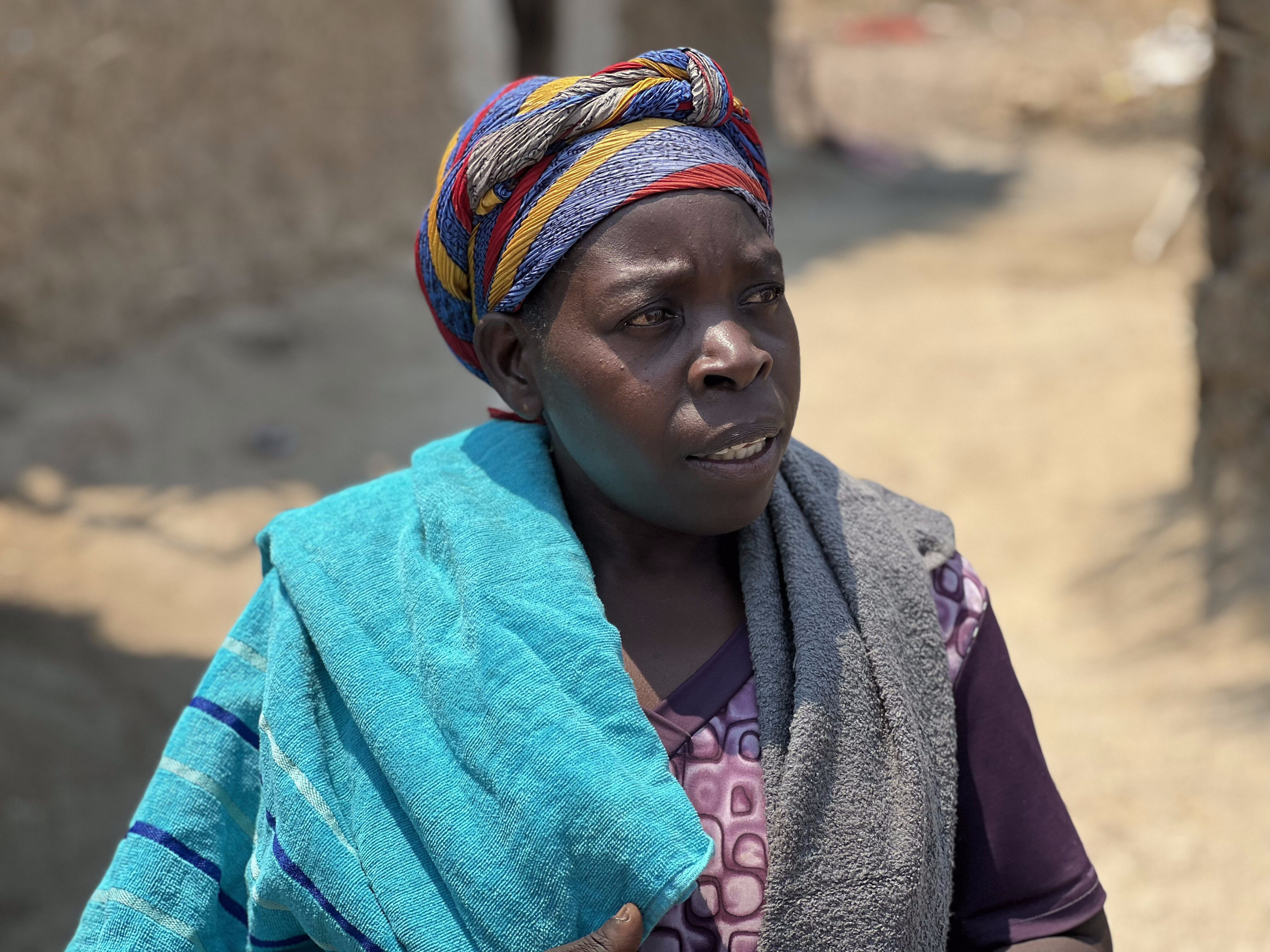 Nyiranshuti Atanaziya speaks with MCC staff at Zambia's Meheba Refugee Settlement Camp.