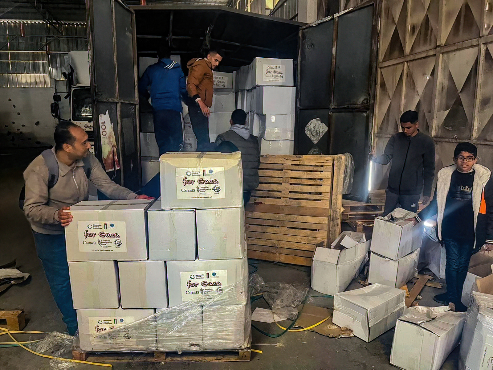 Al-Najd Developmental Forum staff unload emergency food that has just arrived in Gaza for distribution to families in Deir al Balah and surrounding areas.