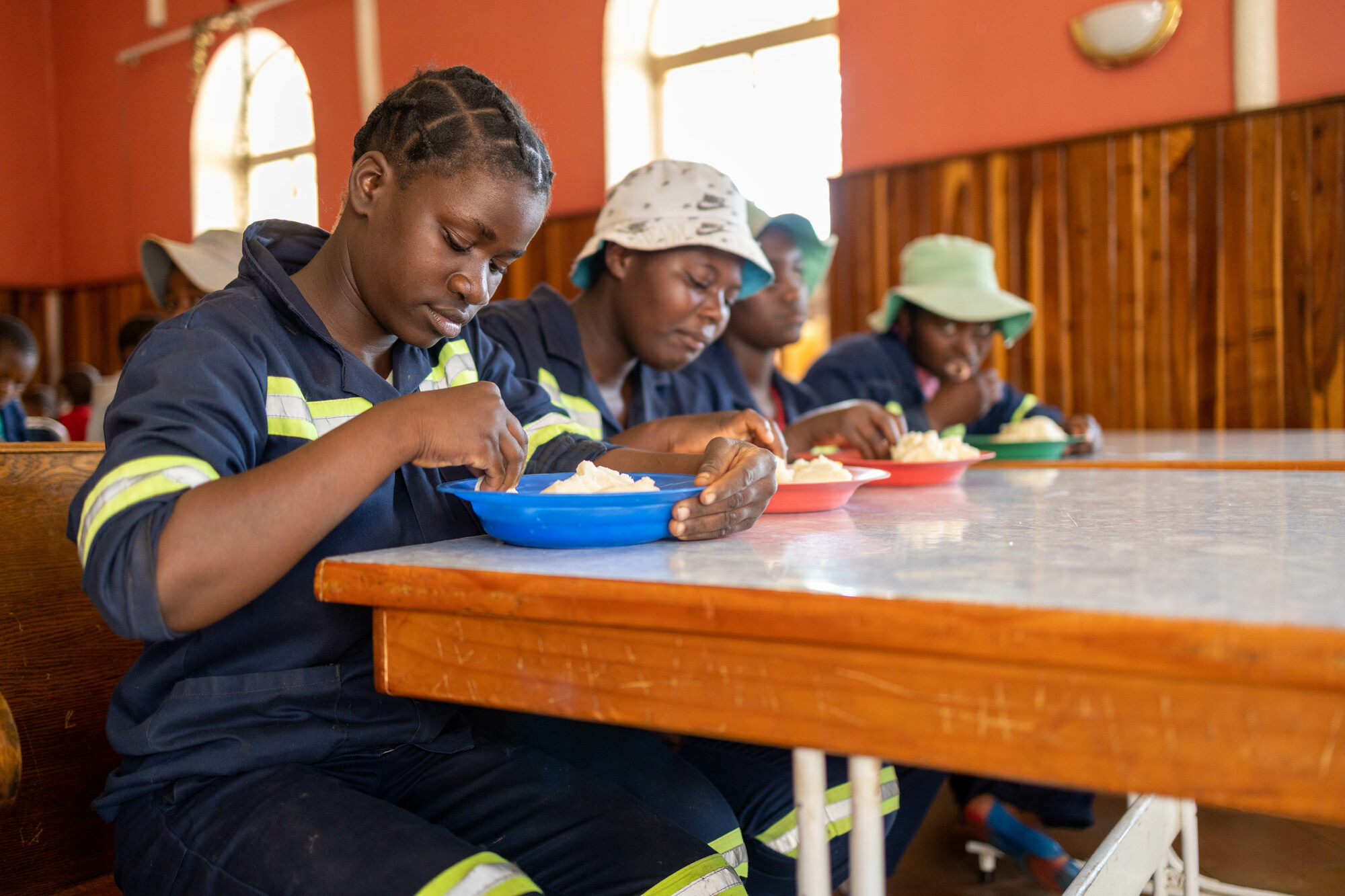 (L to R) Kudzai Sibanlda, Cecilia Khabo, Nodumo Mnkandla and Siphanthisiwe Moyo eat lunch at the Sandra Jones Centre, an MCC partner in Bulawayo, Zimbabwe, that supports orphaned or at-risk girls with health care, education and other social programs. MCC photo/Meghan Mast