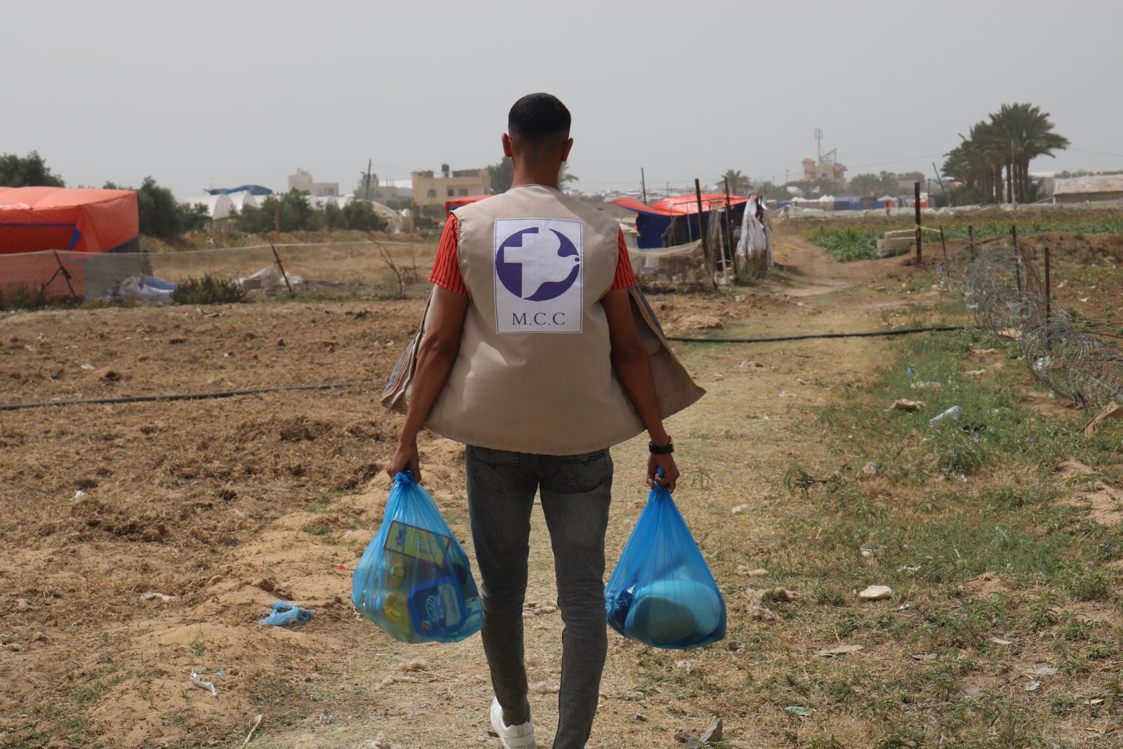 A man carrying two bags of food