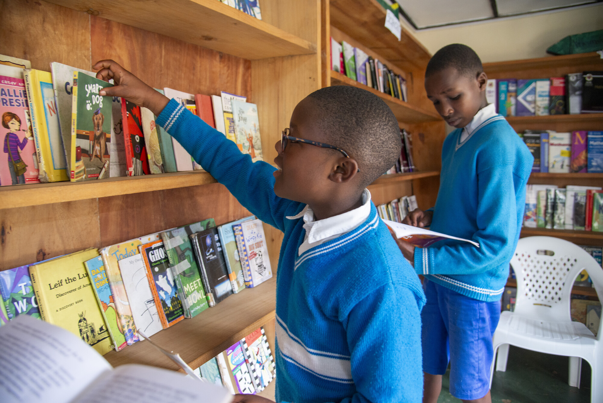 Two boys looking at books.