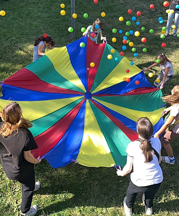 Group playing with a parachute