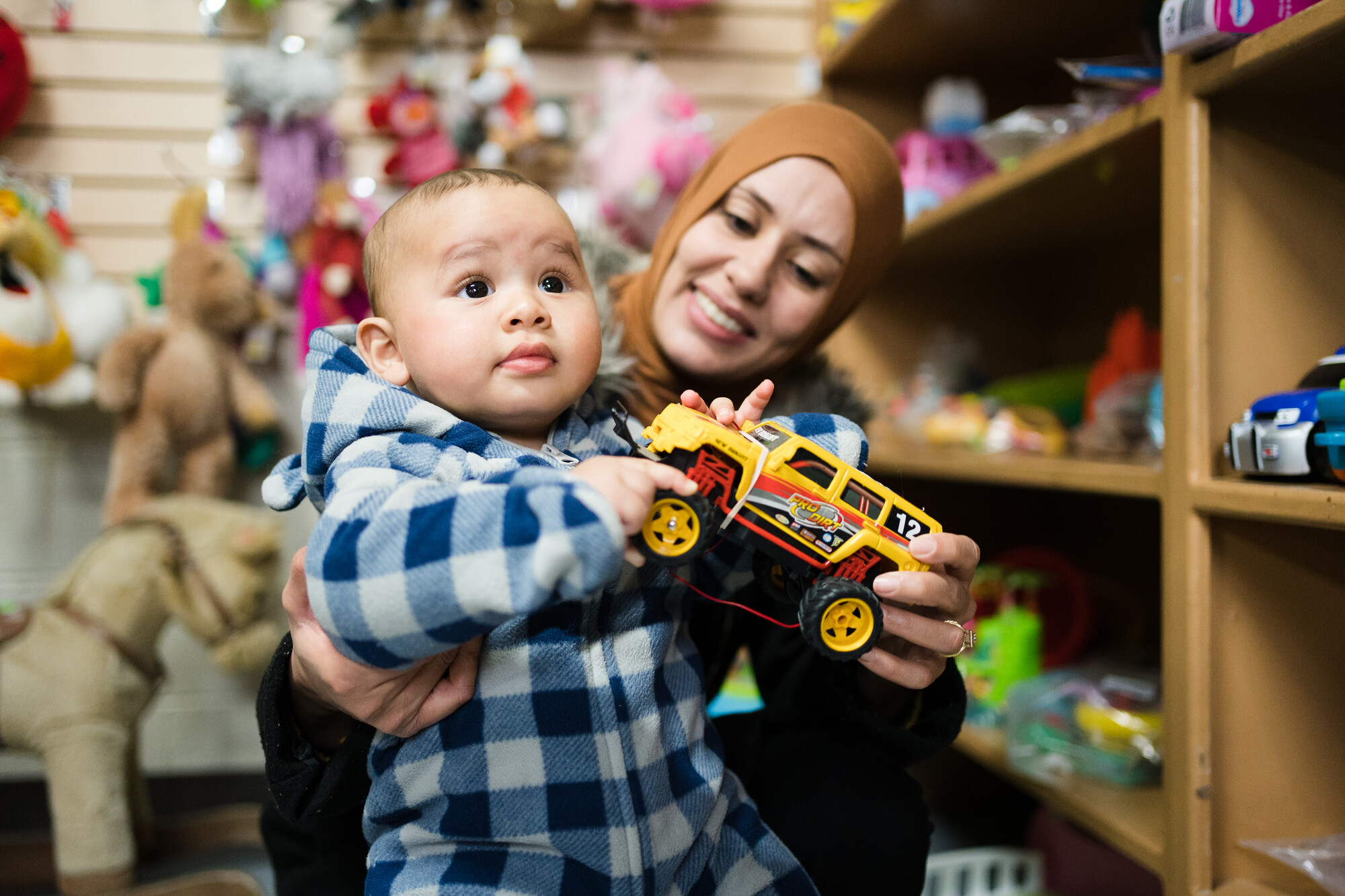 a mother and child choose a toy at the Lethbridge MCC Thrift Shop