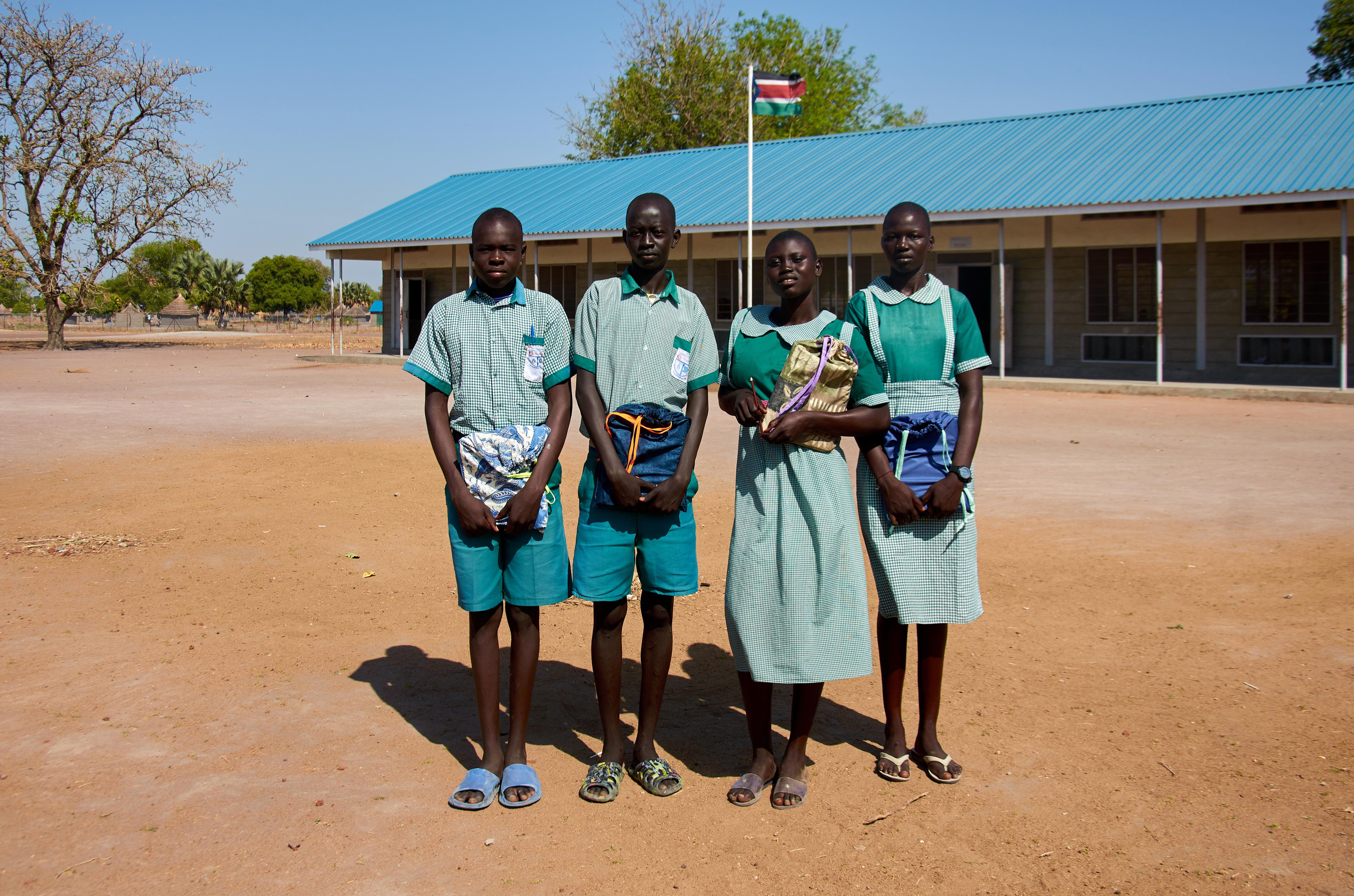 Students at Loreto Secondary School in Rumbek, South Sudan, take a group photo after receiving their MCC school kits.