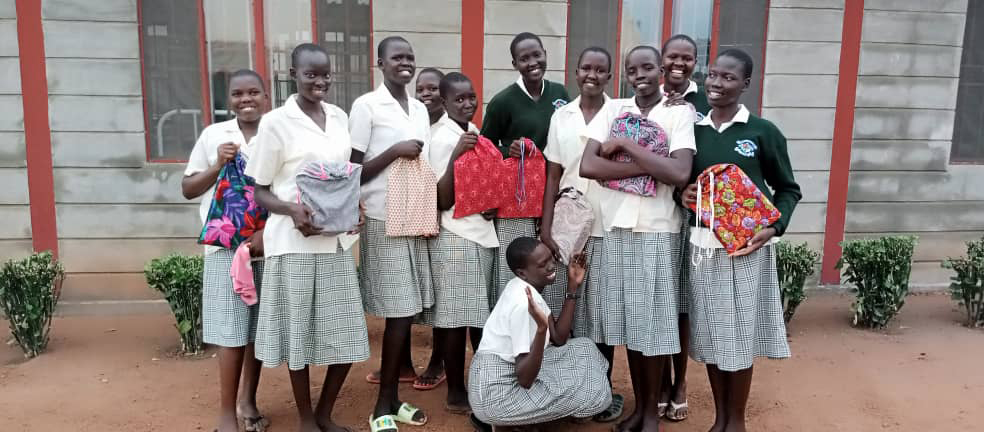 A group of students holding their MCC school kits.