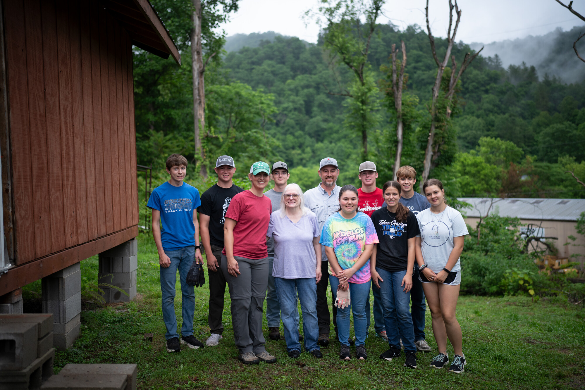 The youth group from Alexanderwohl Mennonite Church in Gossel Kansas stand with Dottie Fleming, center, after working on her home in Virgie, Kentucky for a week.