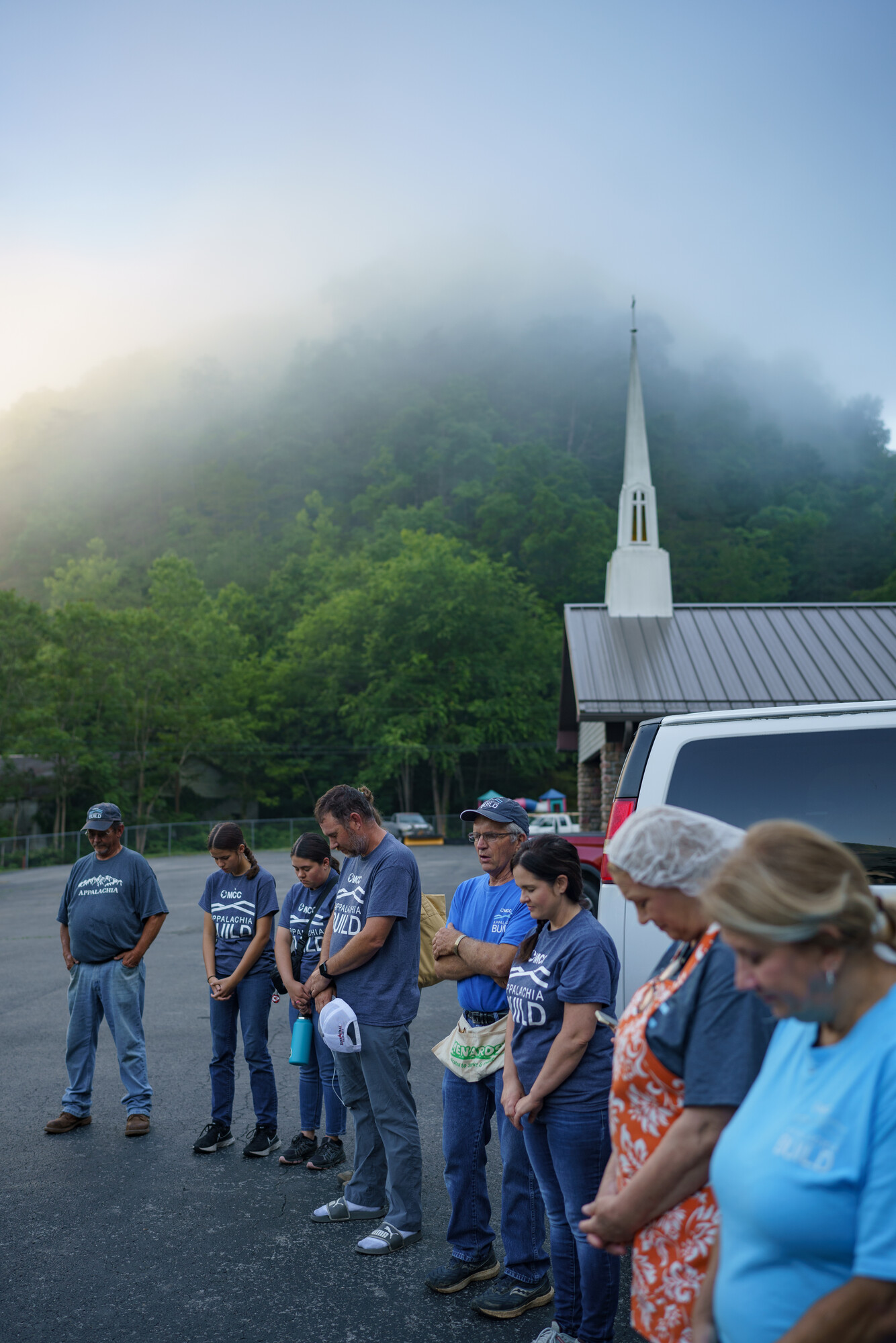 Misty Appalachian mountains in the morning at Elkhorn Community Church. The volunteer groups and the staff circle for a prayer before they start their day.