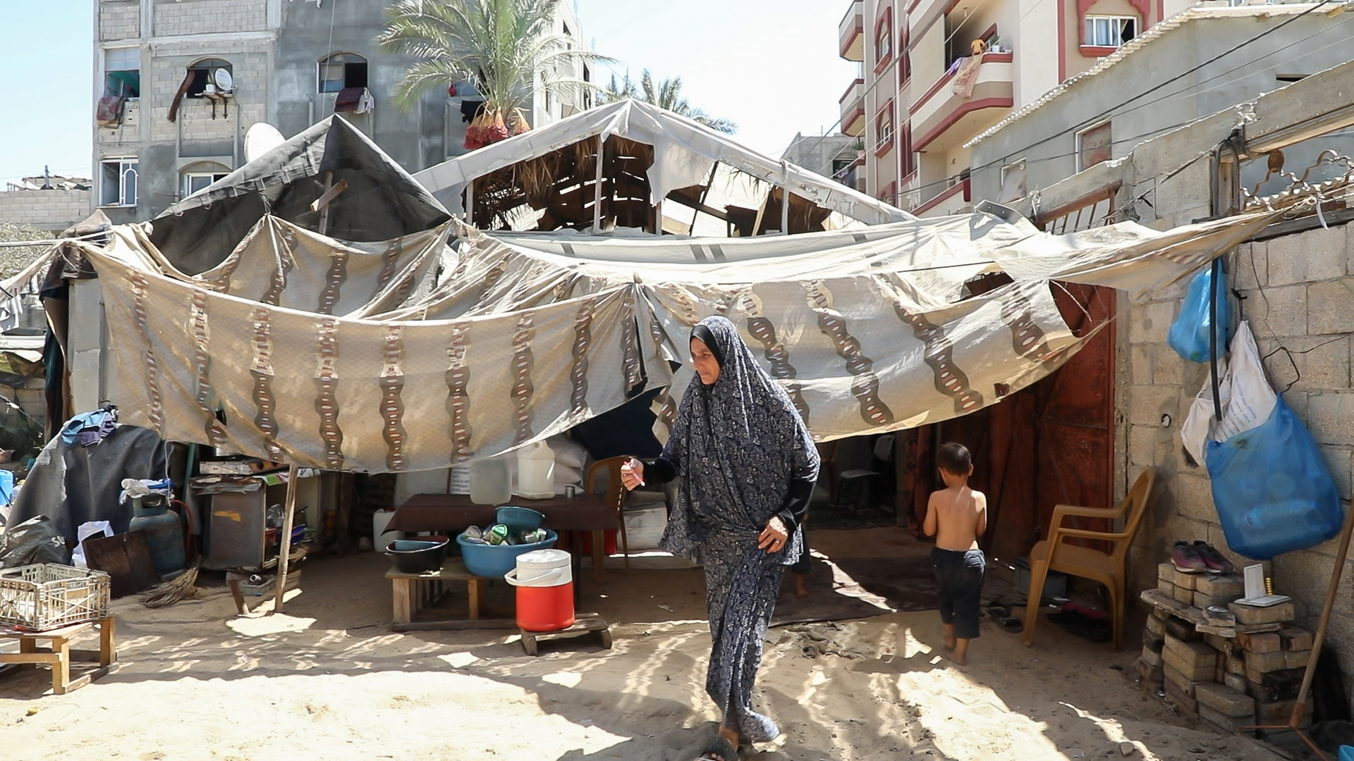 woman walking in front of tent