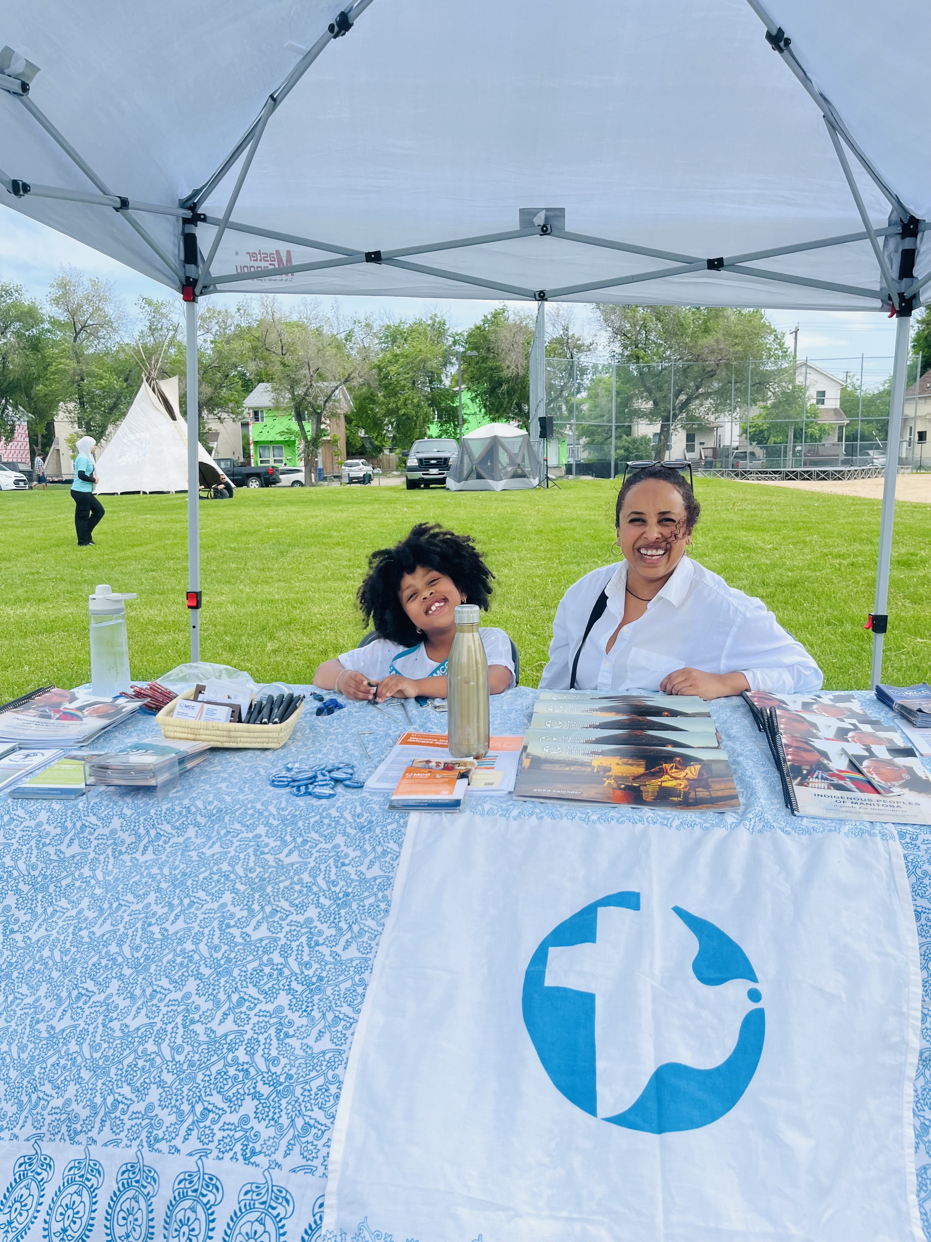 Meron Geberu, migration and resettlement administrative associate for MCC Maniotba, with her daughter at the 2024 Newcomer Welcome Fair and Multiculturalism Day Celebration in Winnipeg