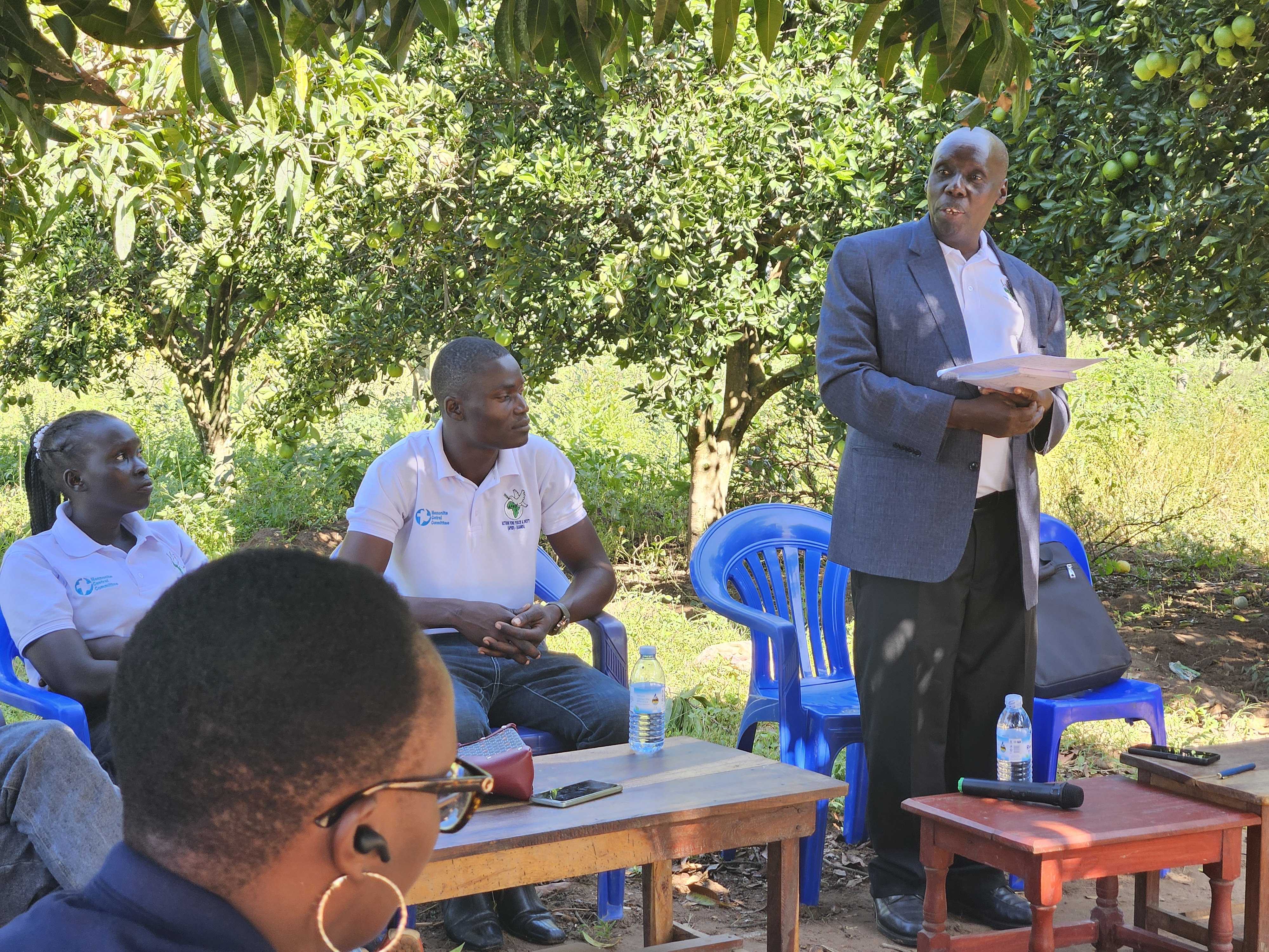 Sam teaches a peace seminar under a tree