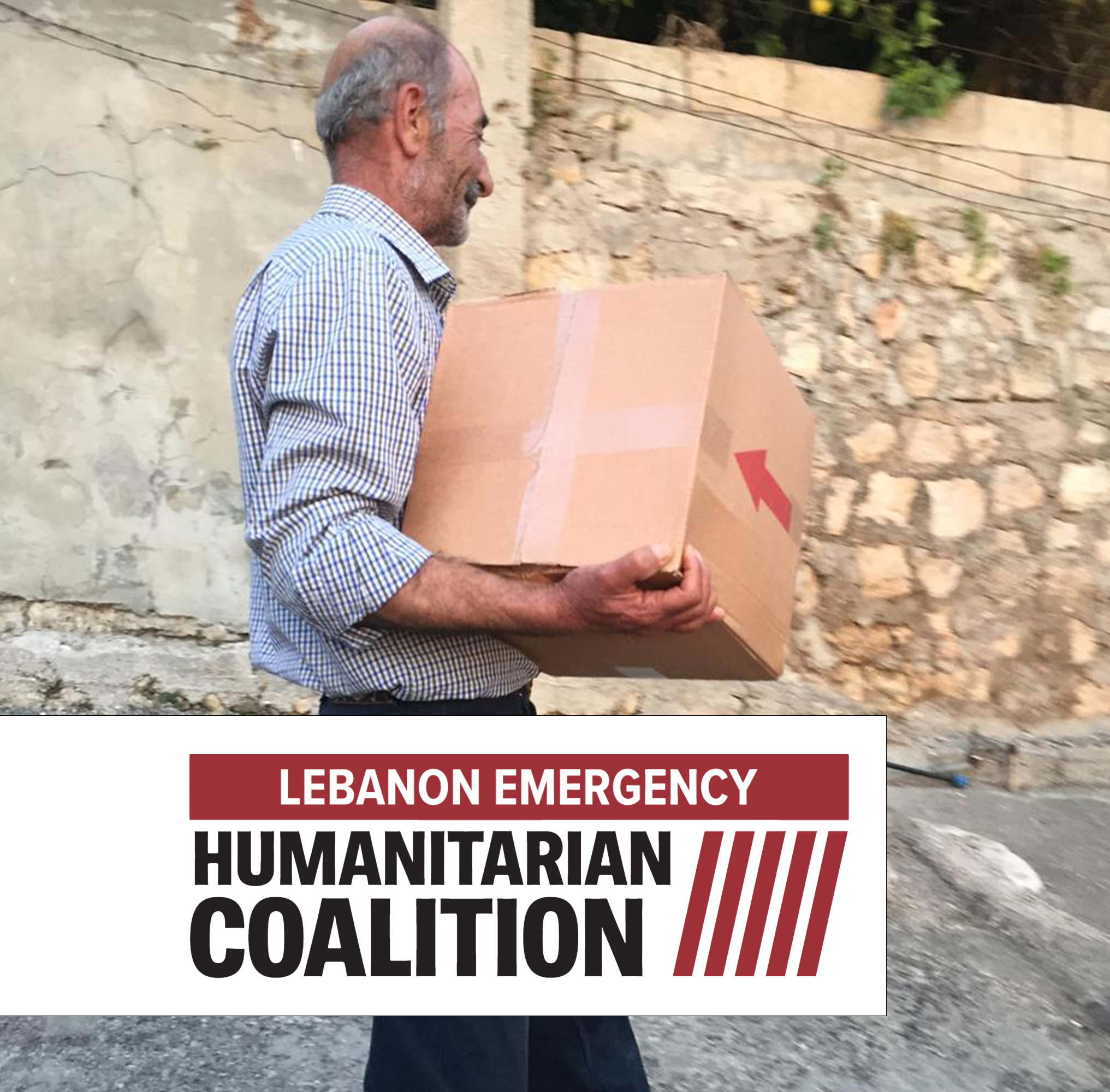 A man holding a cardboard box. A Humanitarian Coalition logo is featured directly below him