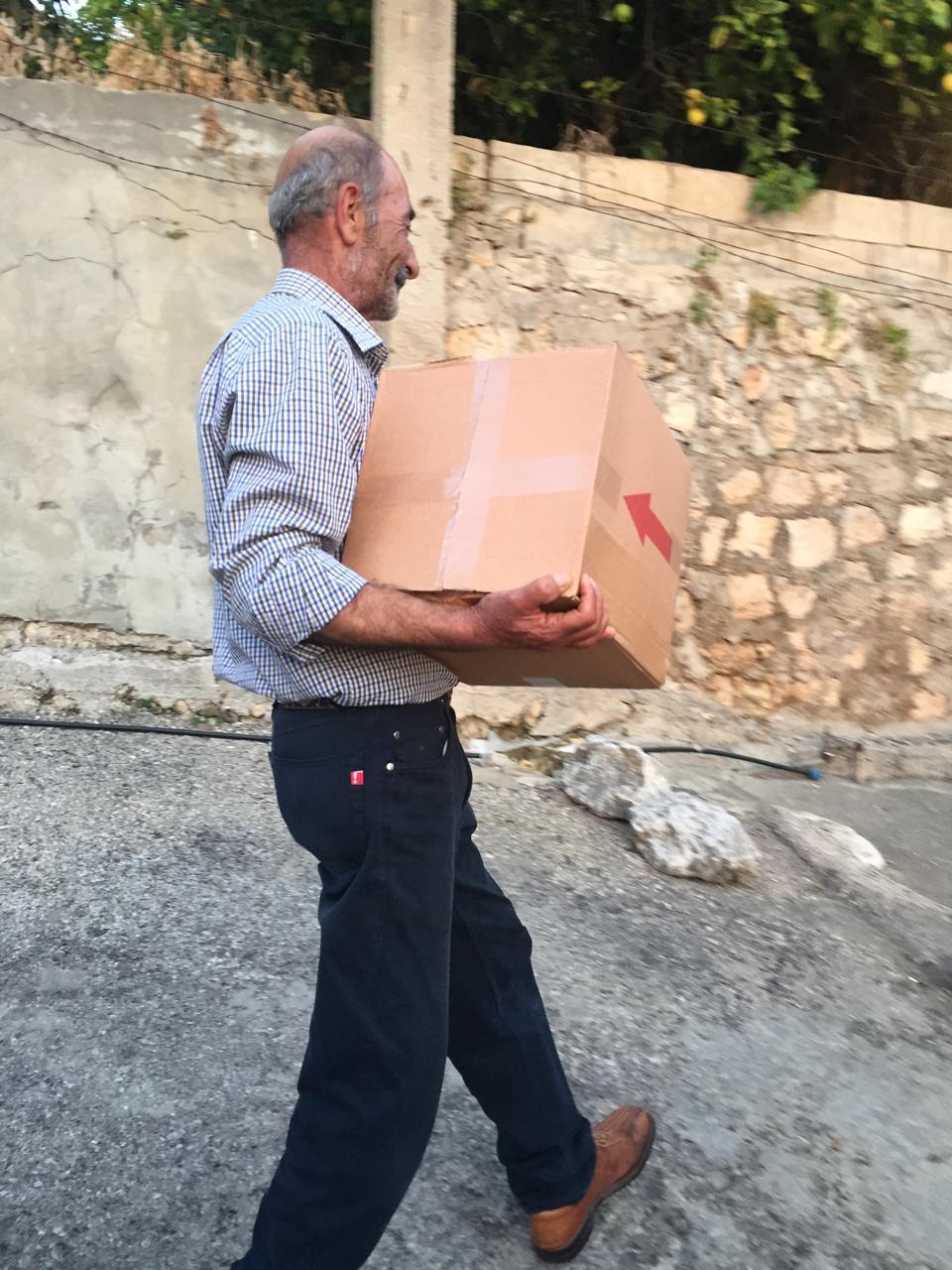 A man carries a cardboard box