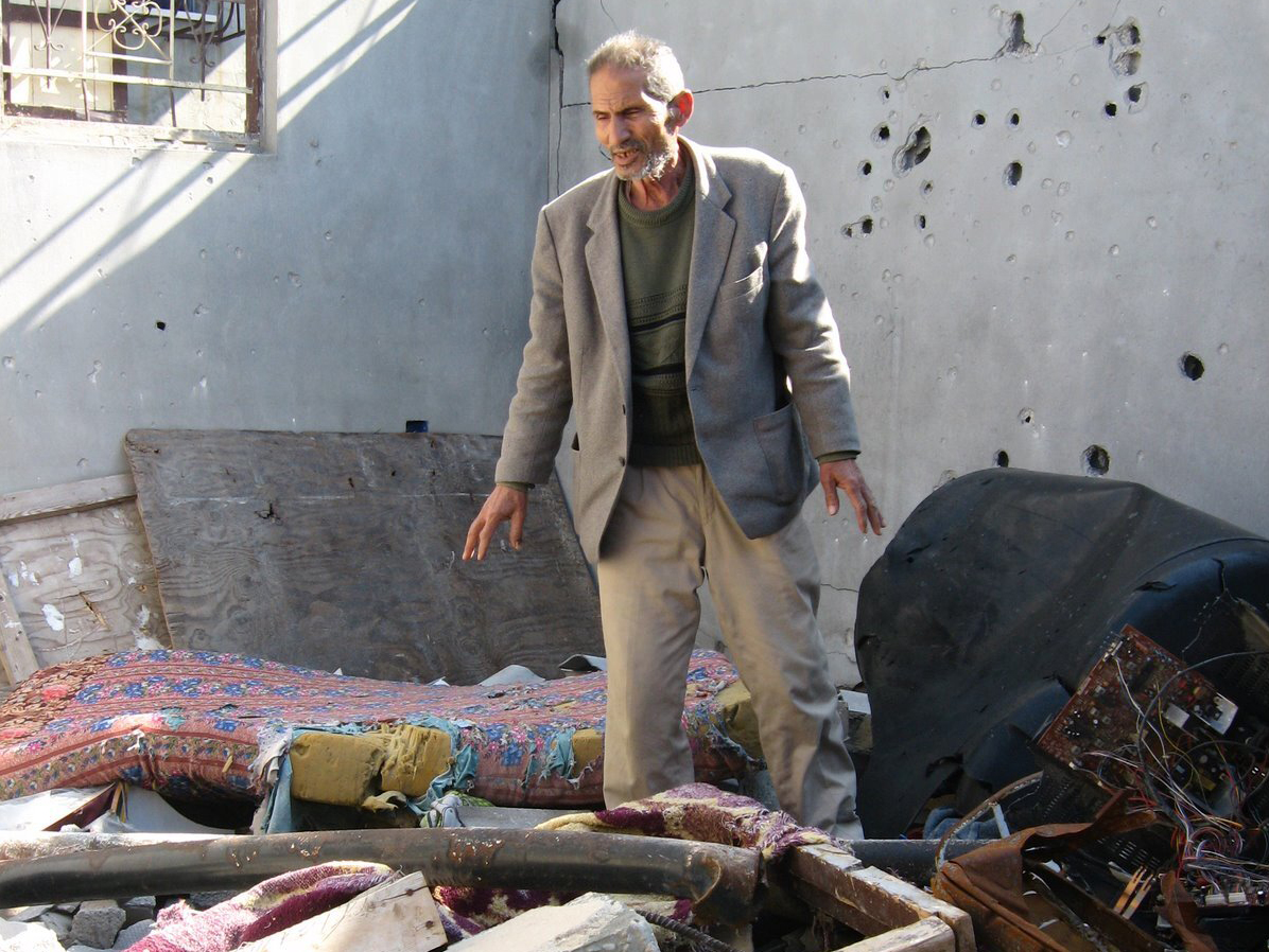 man standing in rubble