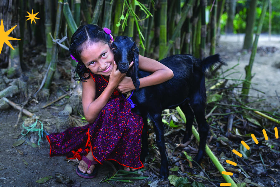 A girl embracing a goat.