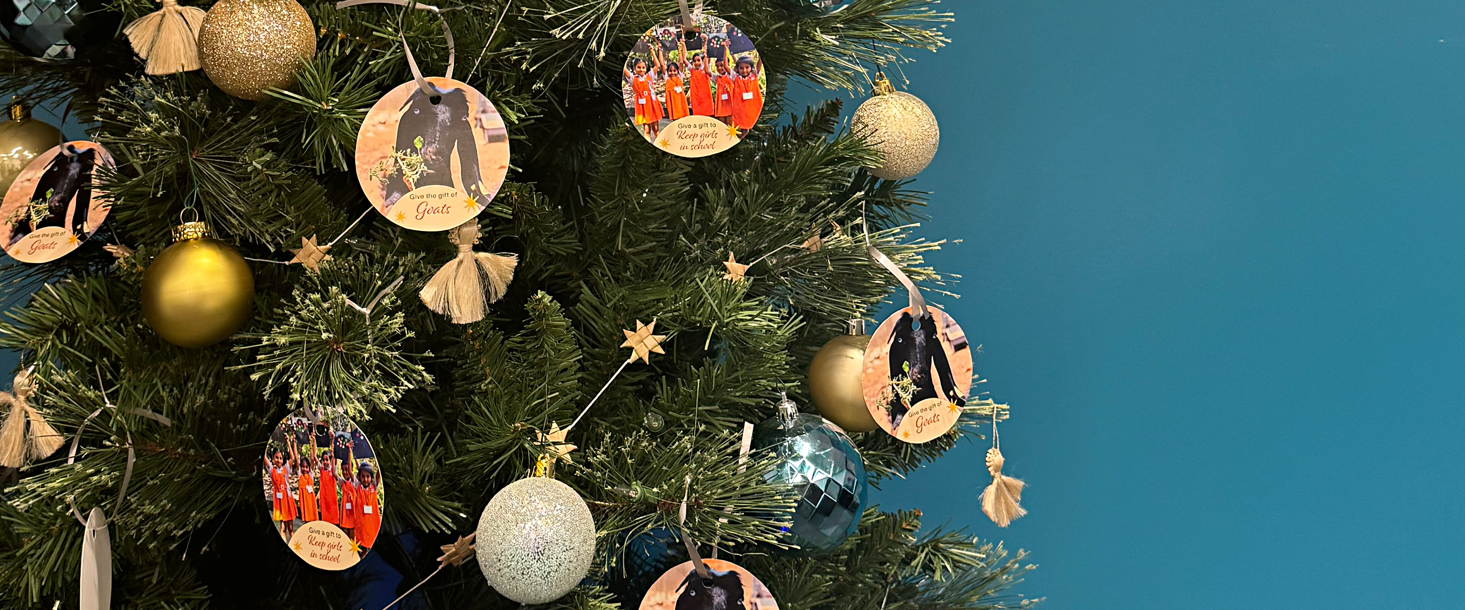 A Christmas tree with various wooden ornaments promoting MCC's Christmas Giving campaign.