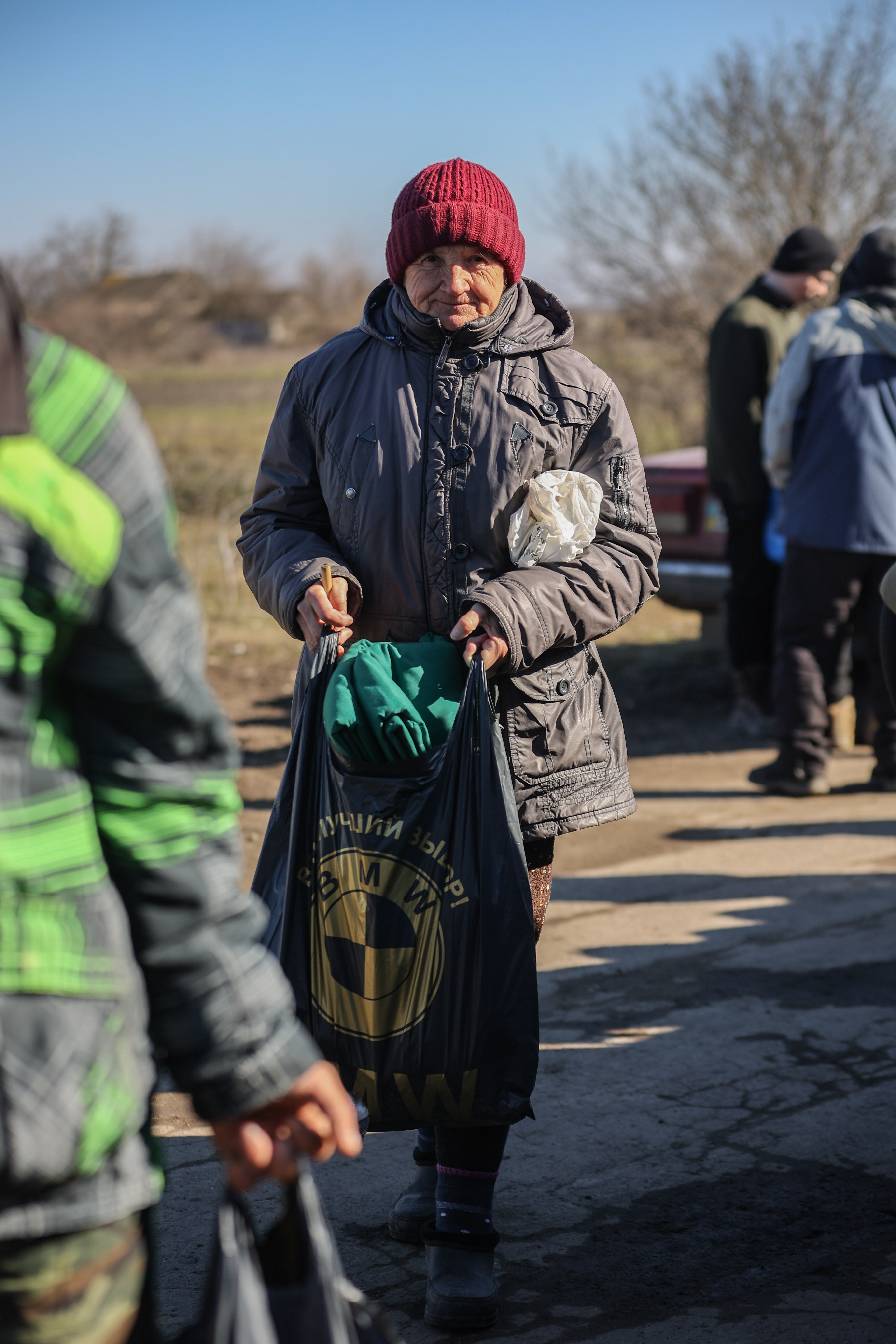 A woman* in a village recovered from Russian military control in Ukraine's Kherson region received a food package, MCC comforter and other essential items from MCC partner Charitable Foundation Uman Help Center (Uman Help Center) in January 2023.