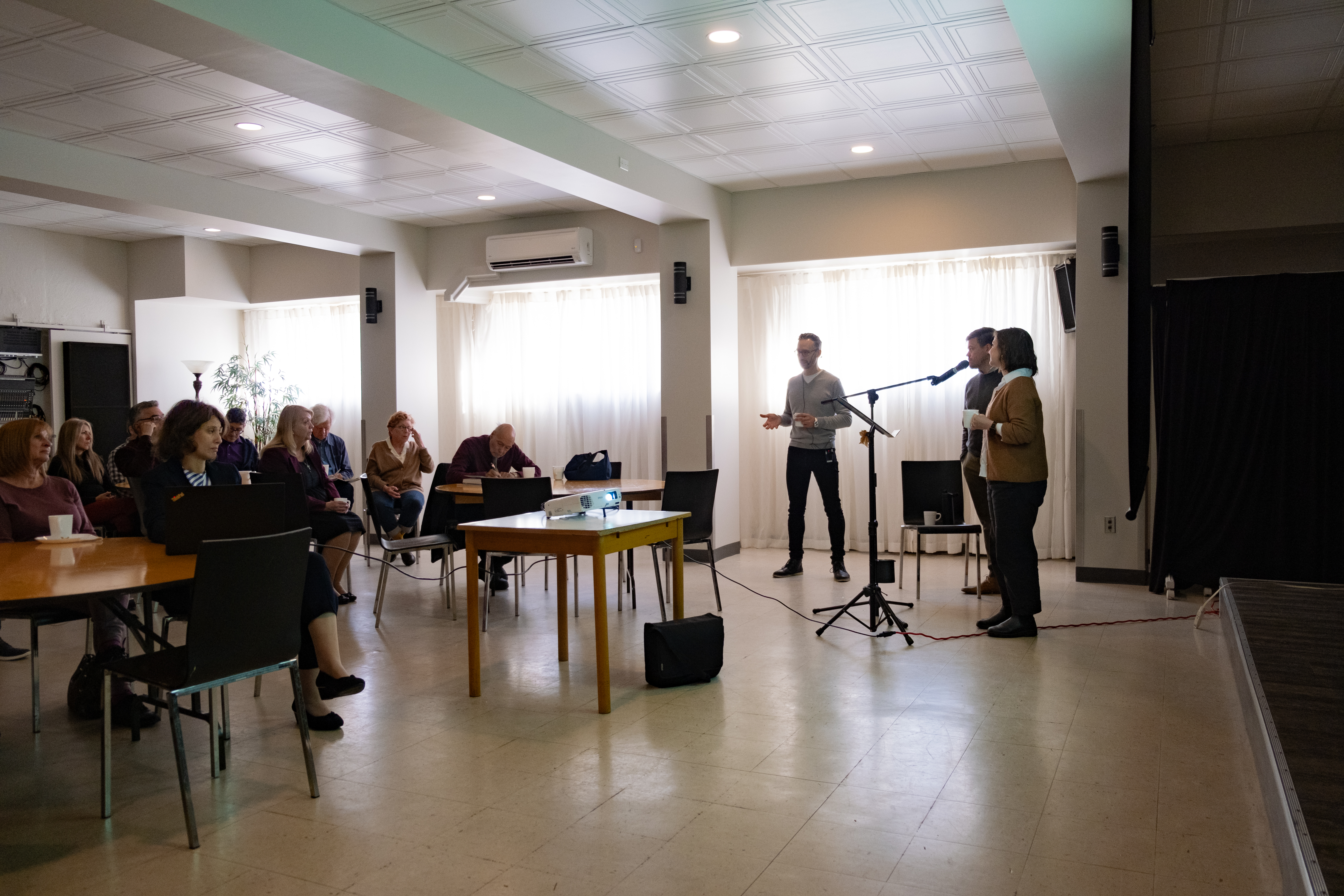 Zacharie Leclair, Sarah Funkhowser and Seth Malone present to a group in Montreal.