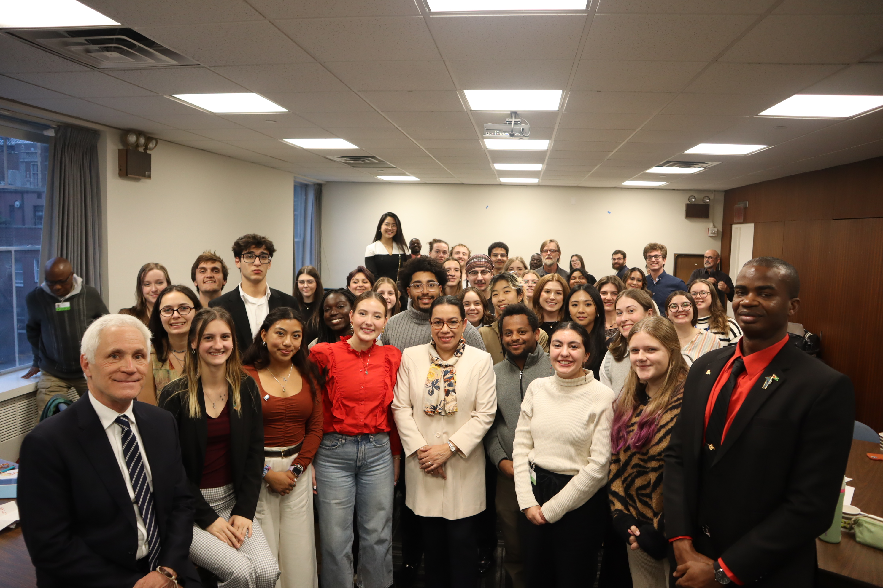 UN student seminar students gather for a group photo with an Ambassador from Guyana.