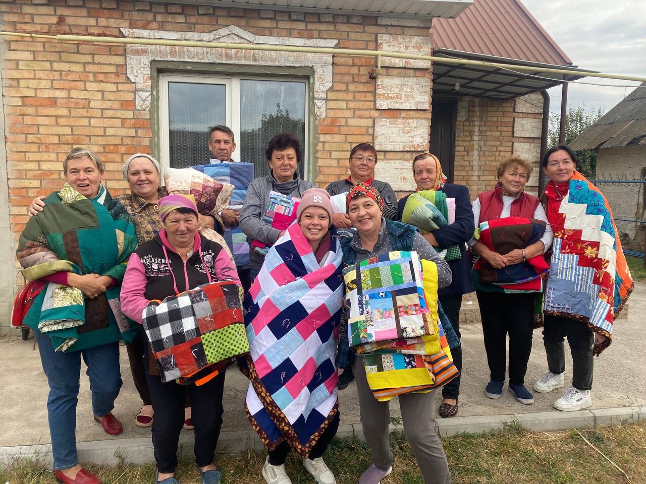 People from Ukraine’s Zaporizhzhia region display MCC comforters received during a distribution by MCC partner Association of Mennonite Brethren Churches of Ukraine. 