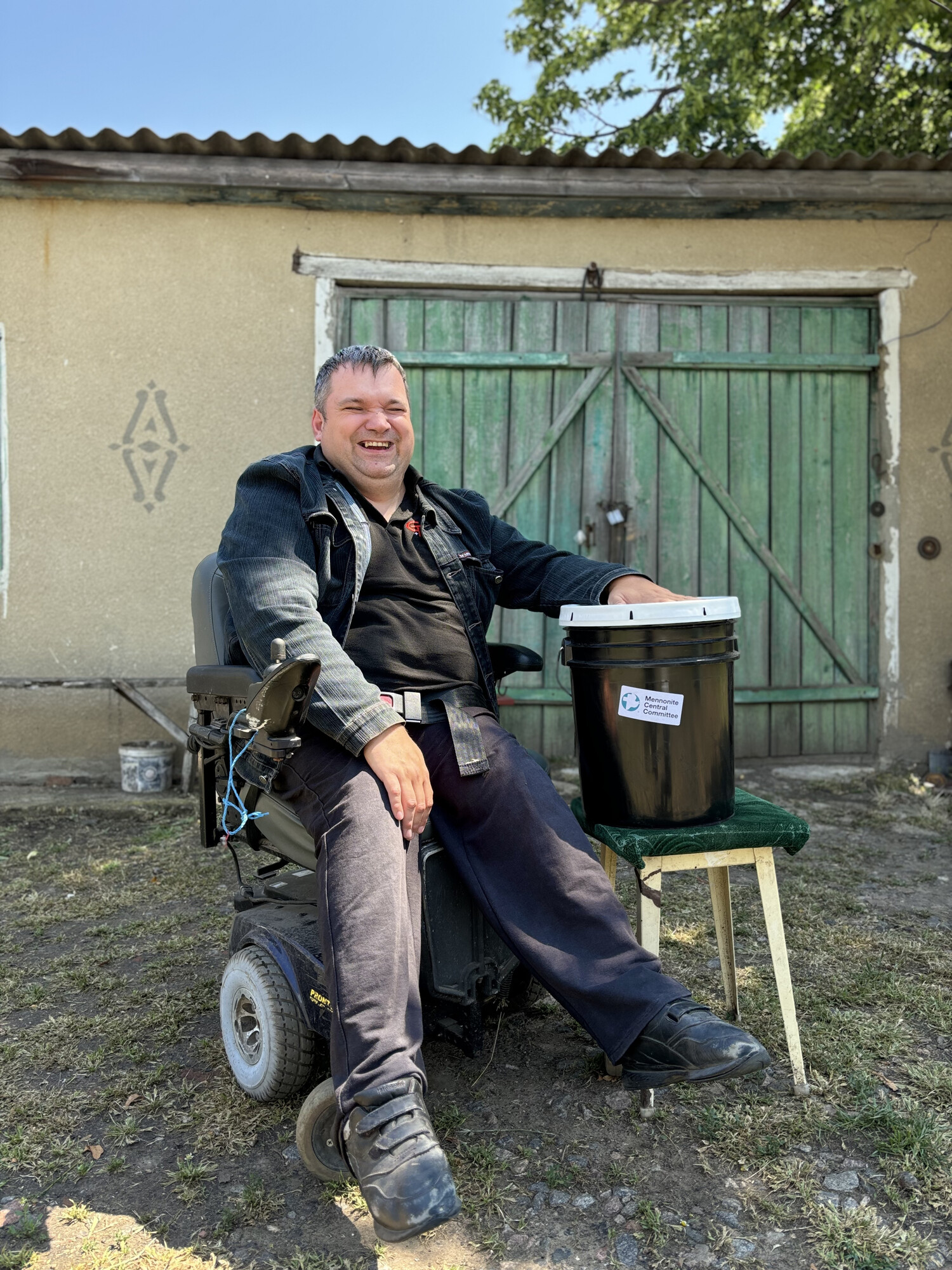 Man sitting in wheelchair beside an MCC relief kit