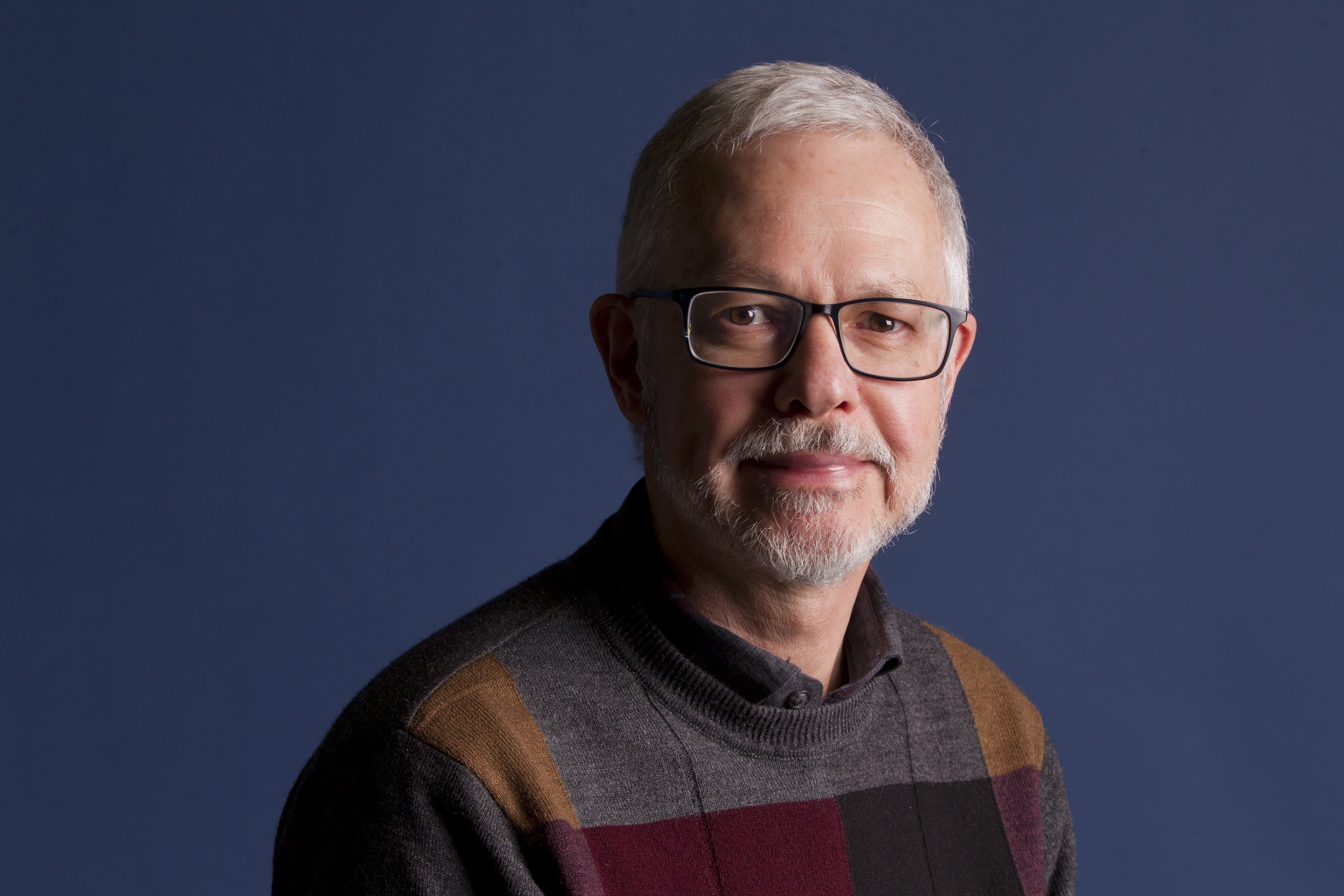 A portrait of a man with glasses