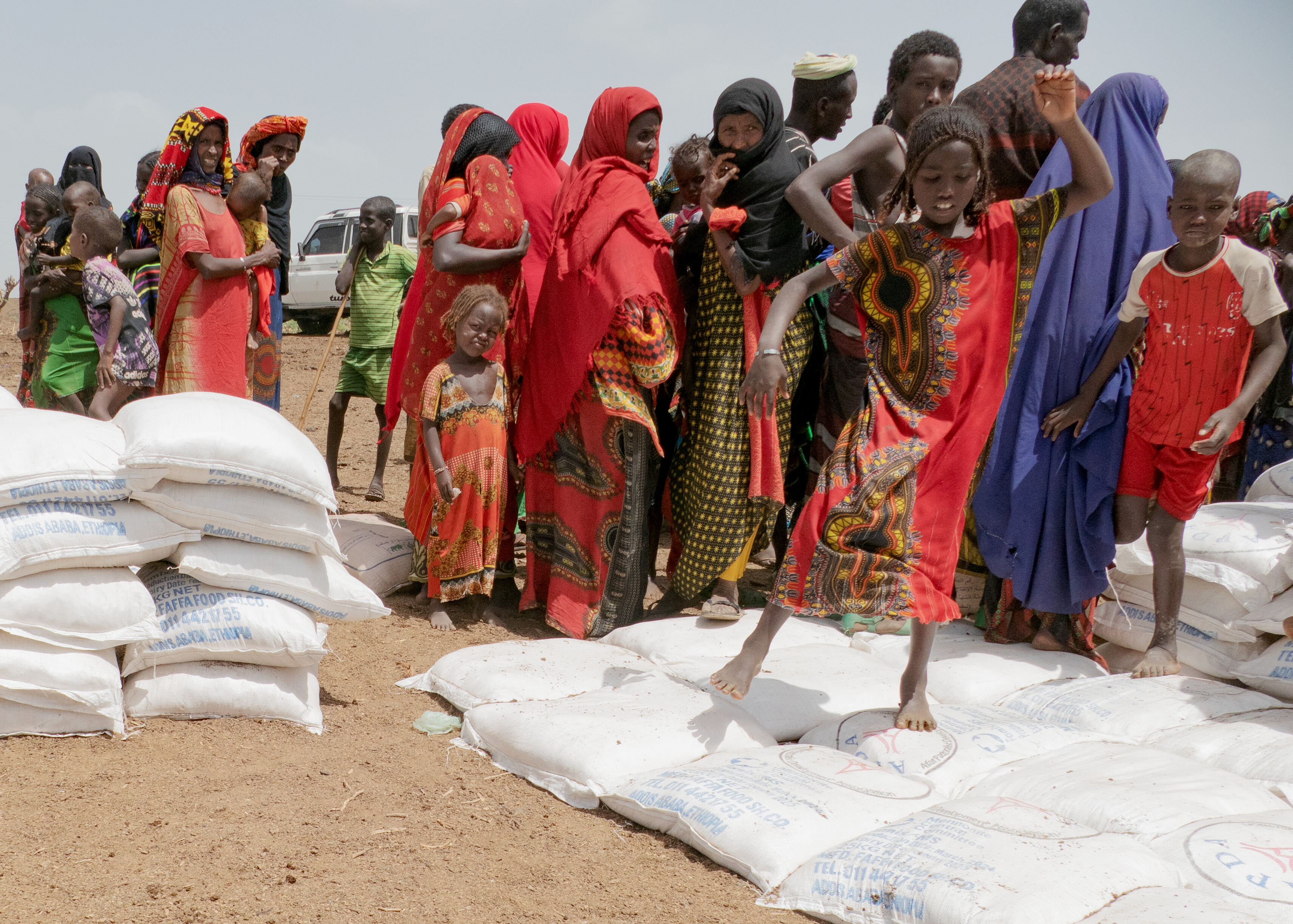 Adeh Hamed, holding her son Mohammed Musa (2 years old), waits to receive emergency food rations for malnourished women and children in Burimudayto Woreda on March 30, 2024, where ongoing drought conditions have killed livestock and crops. Many of the children were recovering from a measles outbreak, but were extremely frail.