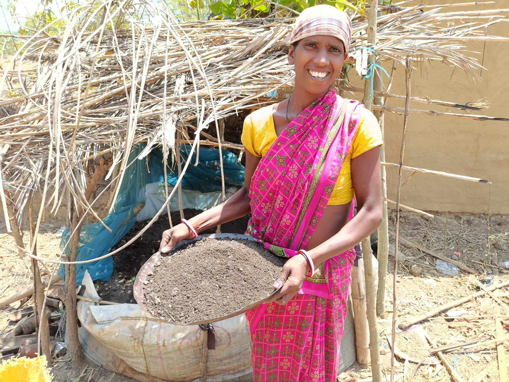 Seteng Markey developed a vermi-compost pit at her home in Bartoli village where MCC funds a project through its account at Canadian Foodgrains Bank to improve food and nutrition security in Indigenous communities. She is a beneficiary of the project implemented by MCC's local partner DISHA. She is collecting compost to use on her crops.