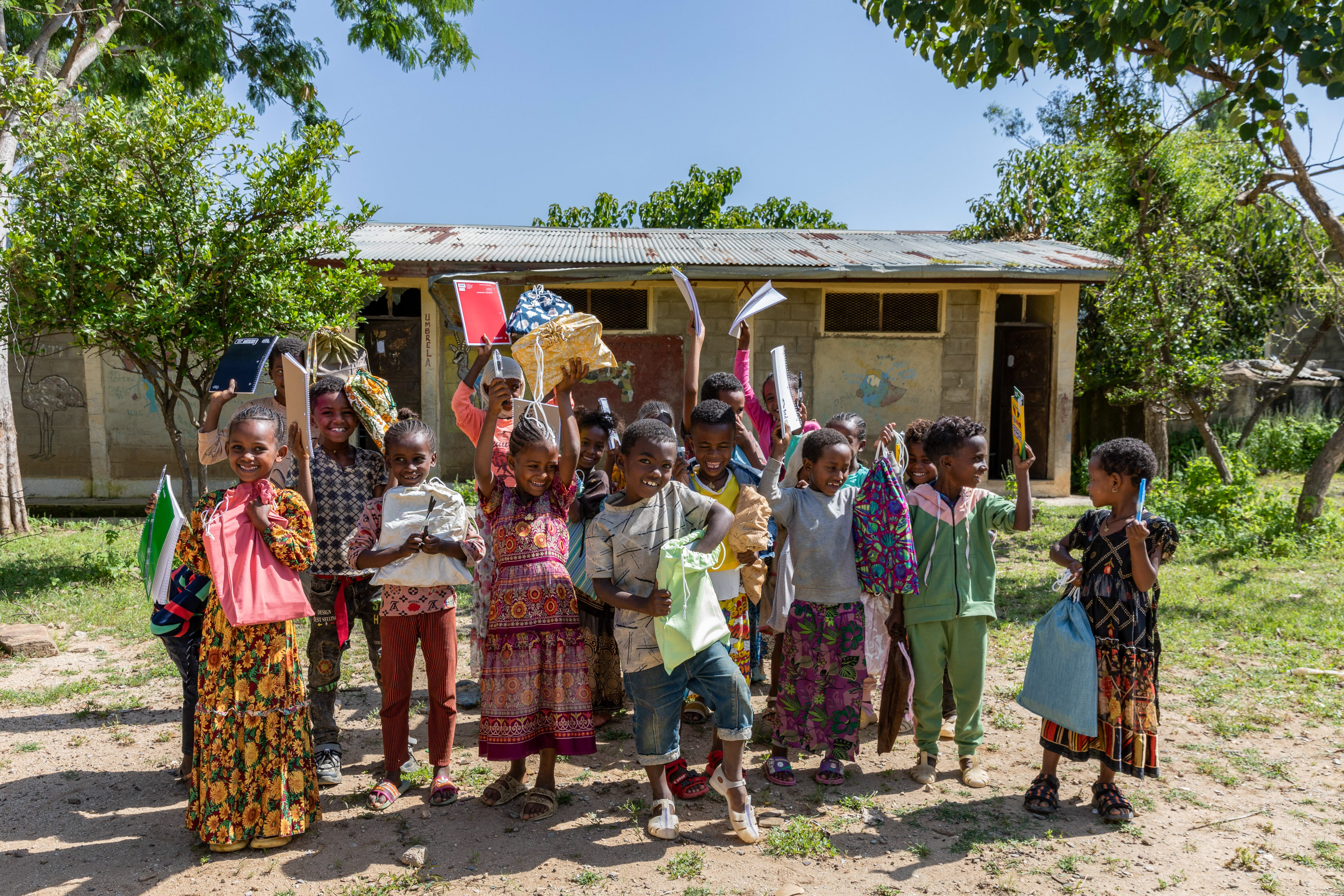 Students pose for a group photo after receiving MCC school kits provided by the Meserete Kristos Church Development Commission (MKCDC) at Daero Tekli Elementary School in the Tigray region on 20 September 2024., Students pose for a group photo after receiving MCC school kits provided by the Meserete Kristos Church Development Commission (MKCDC) at Daero Tekli Elementary School in the Tigray region on 20 September 2024.