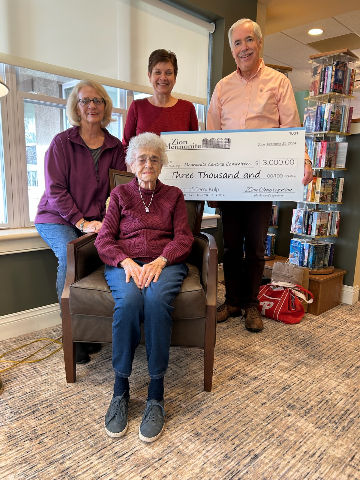 Gerry Kulp is presented with a big check from her pastors