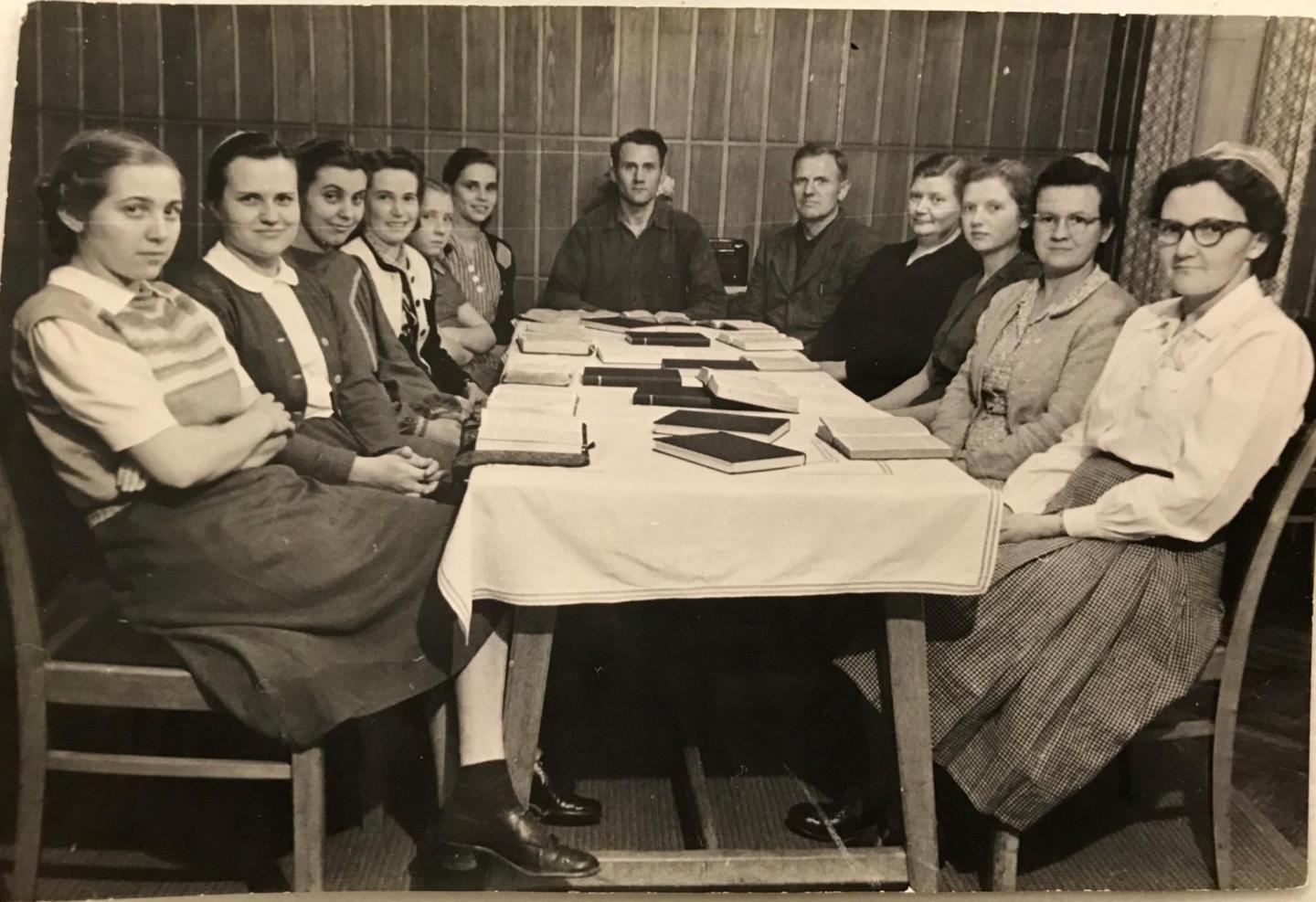 Group of people sitting around a table.