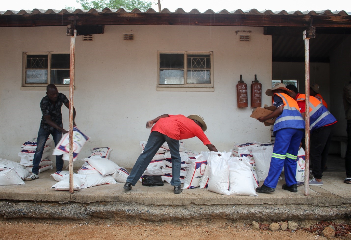 Group of men with bags of rice