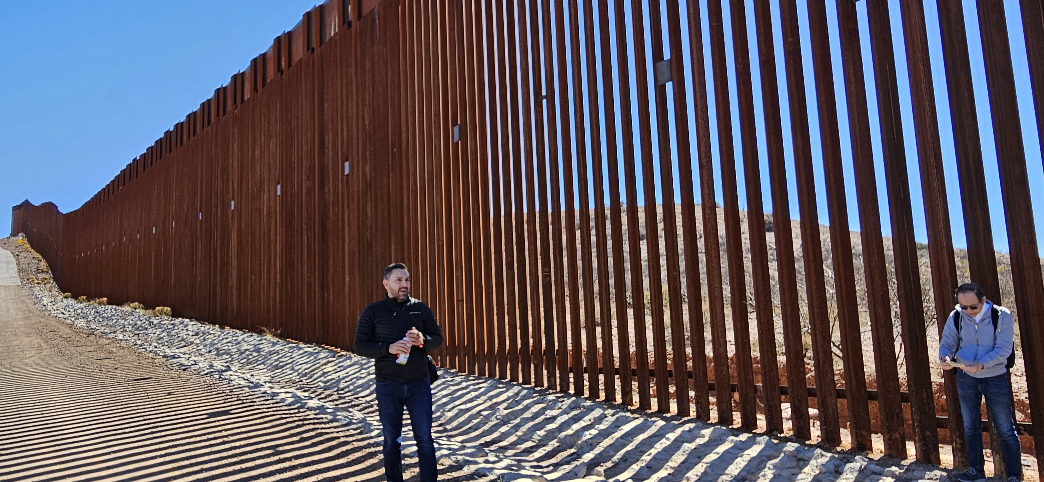 Man stands in front of wall