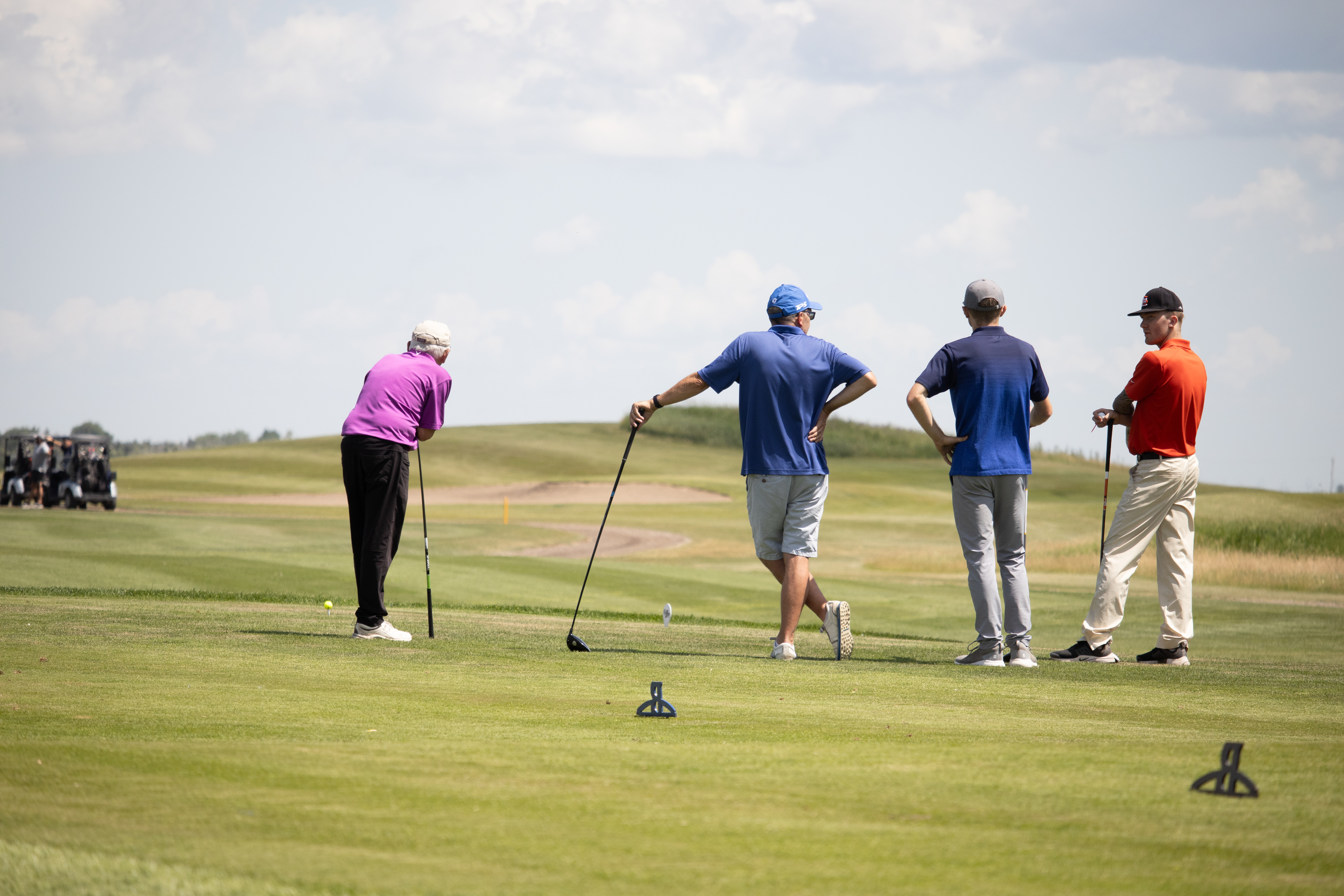 Four golfers on the golf green