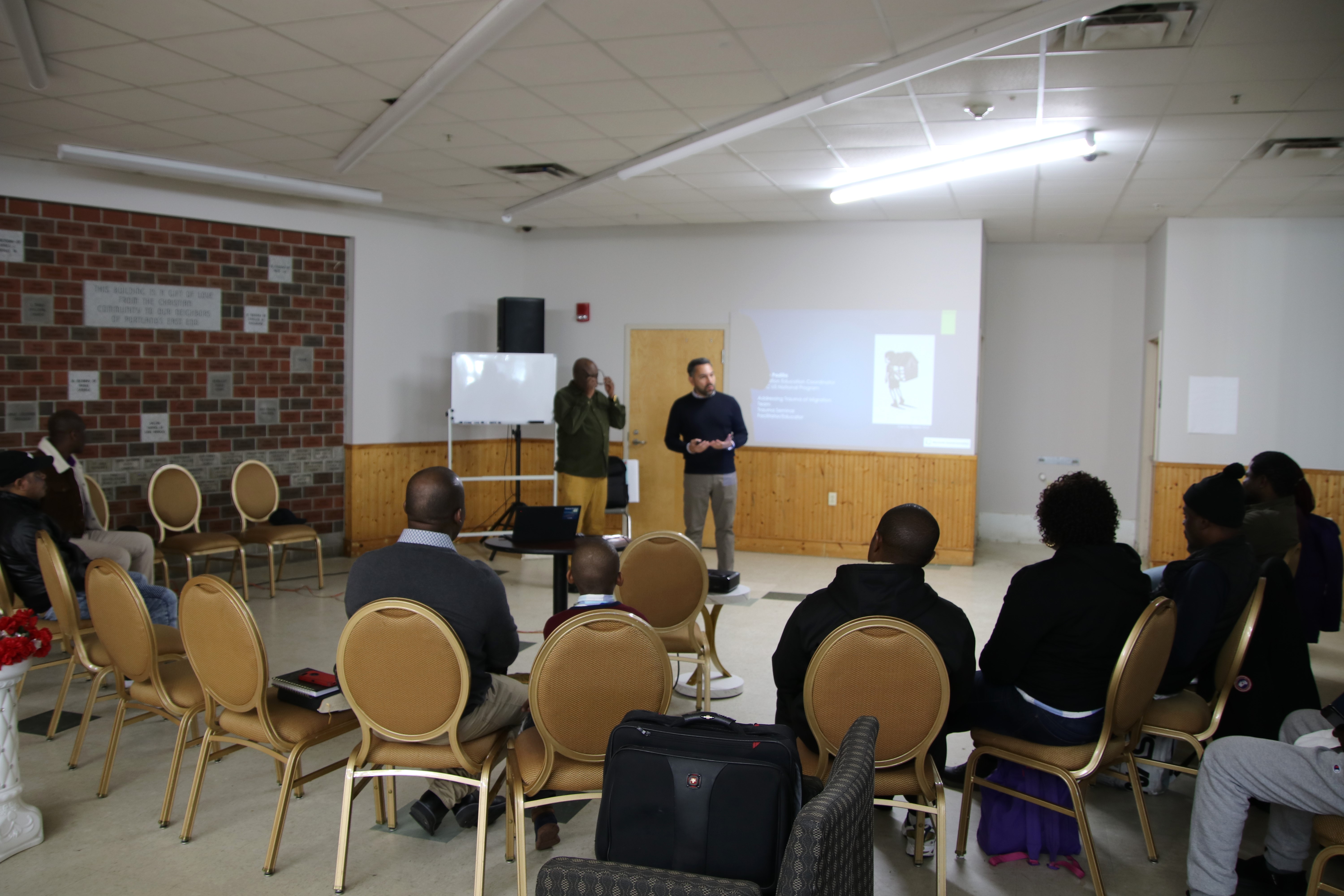 MCC staff gives a presentation to a group of immigrants