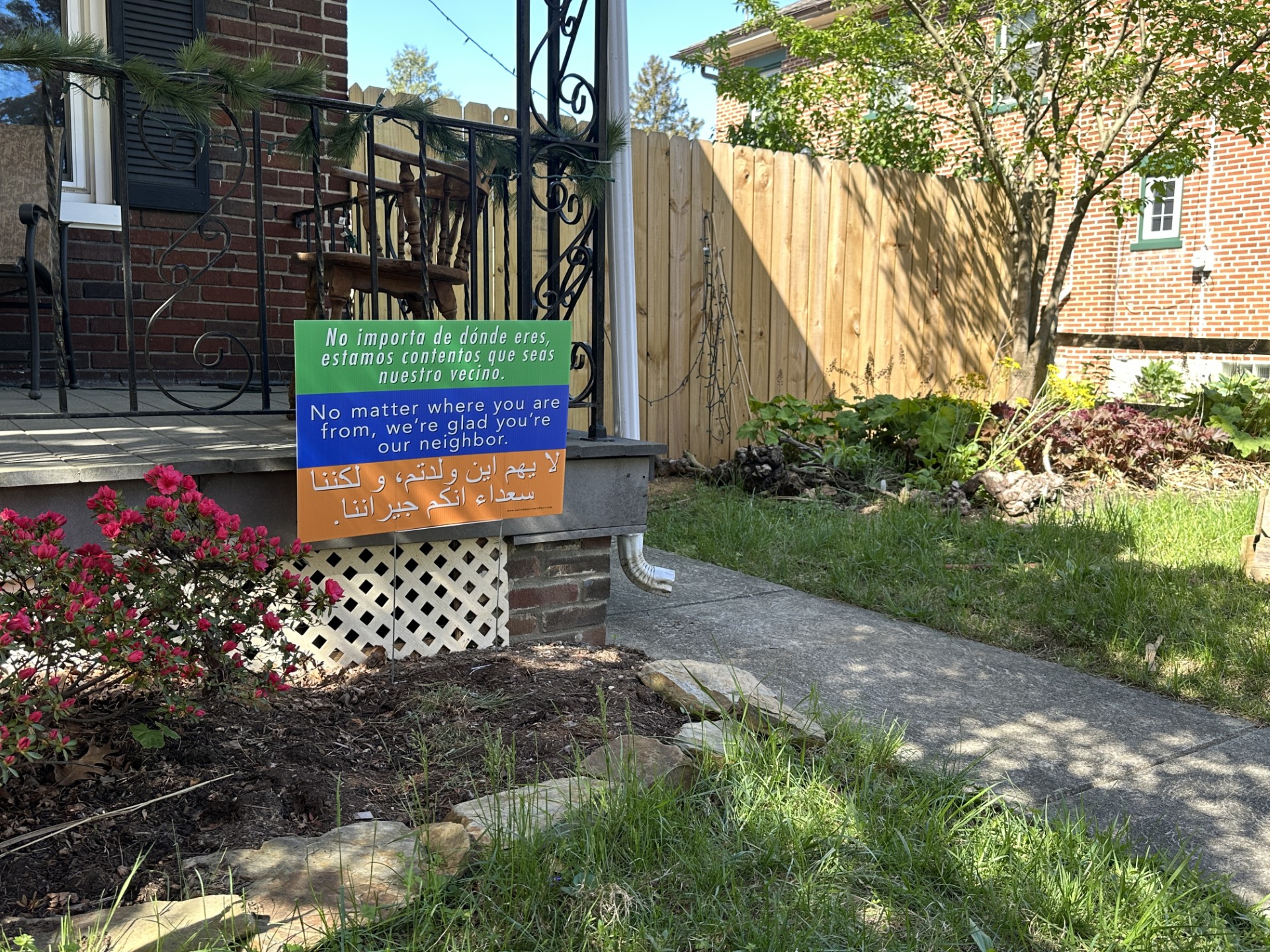 tri-color welcome sign in a yard