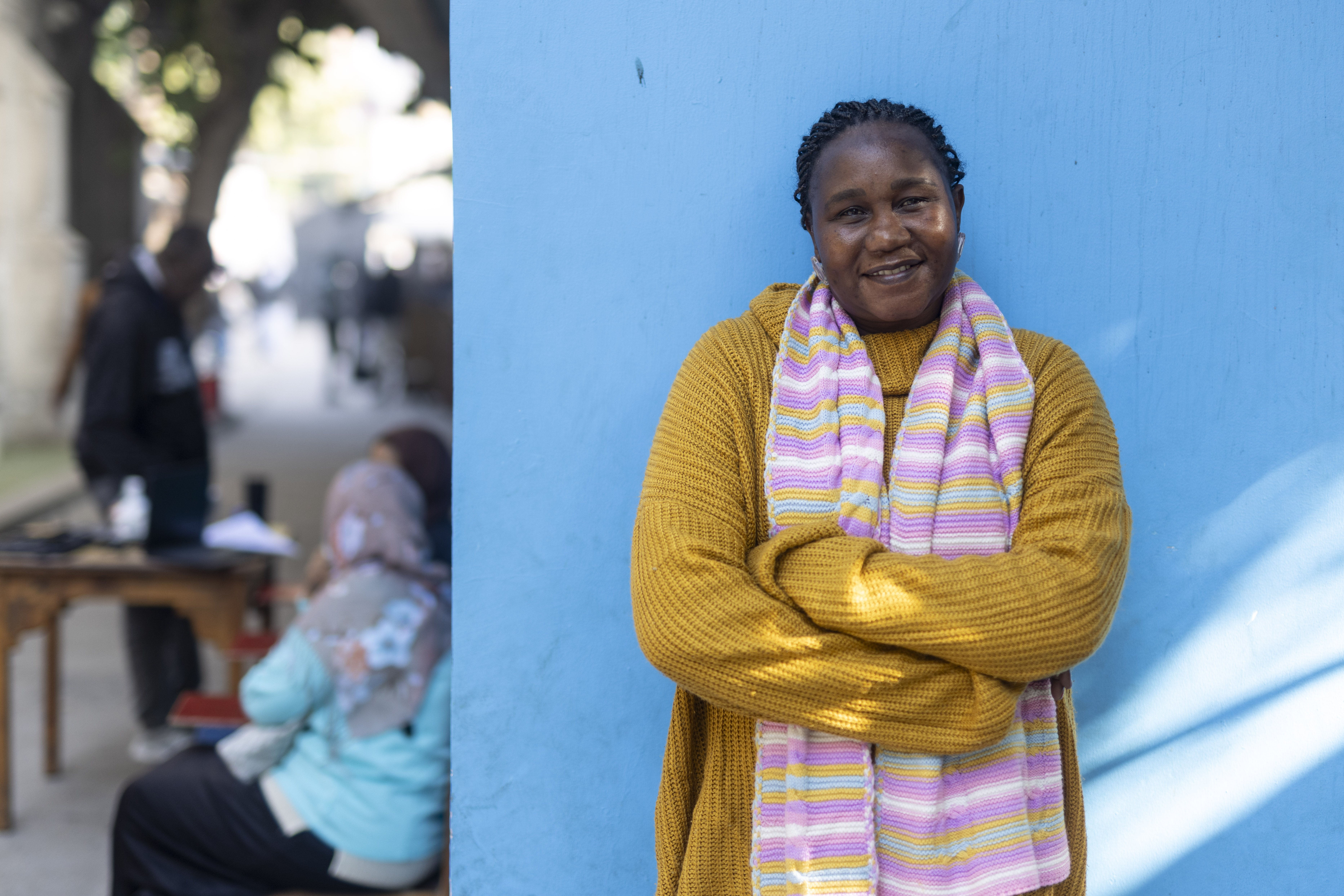 A coordinator with MCC partner StARS stands in front of a wall. She helps refugees in Cairo who are seeking support. 