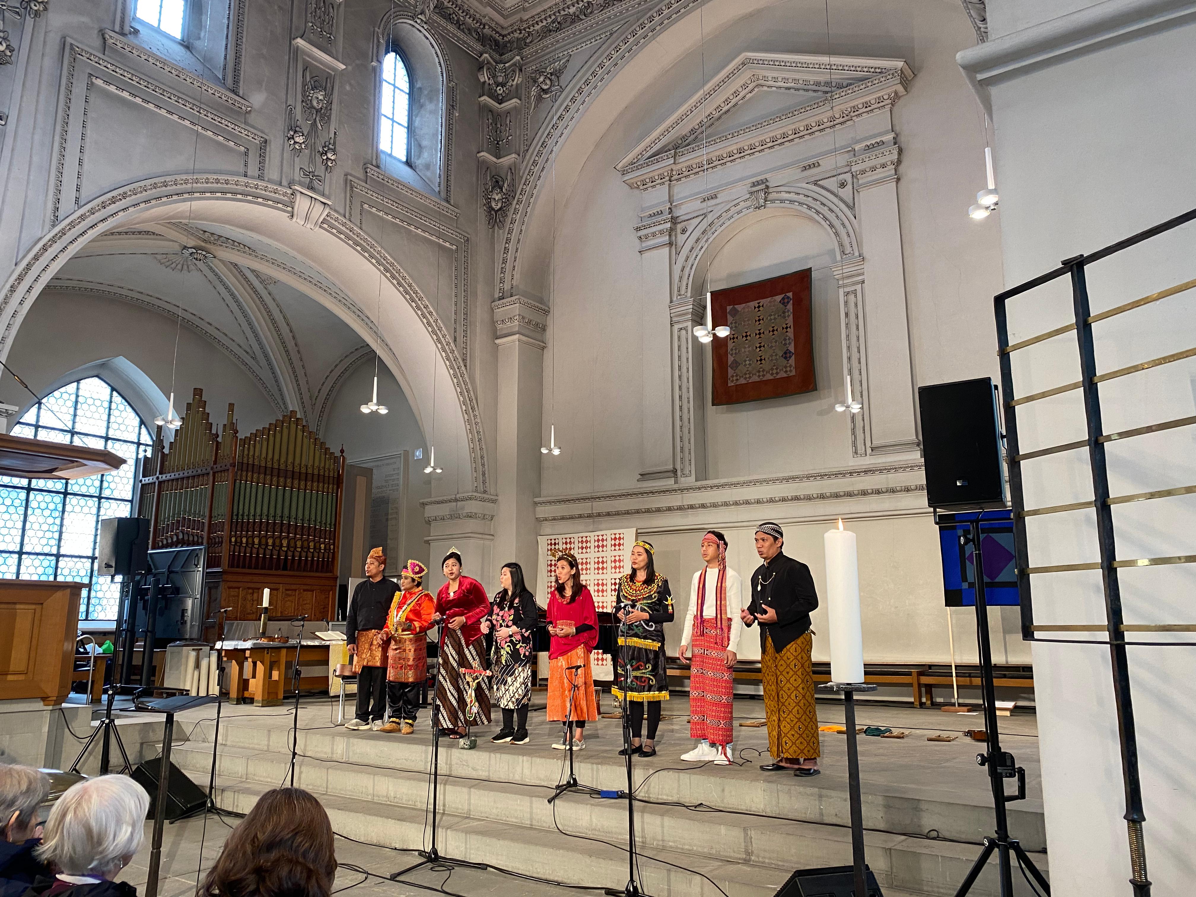 A choir stands in a church